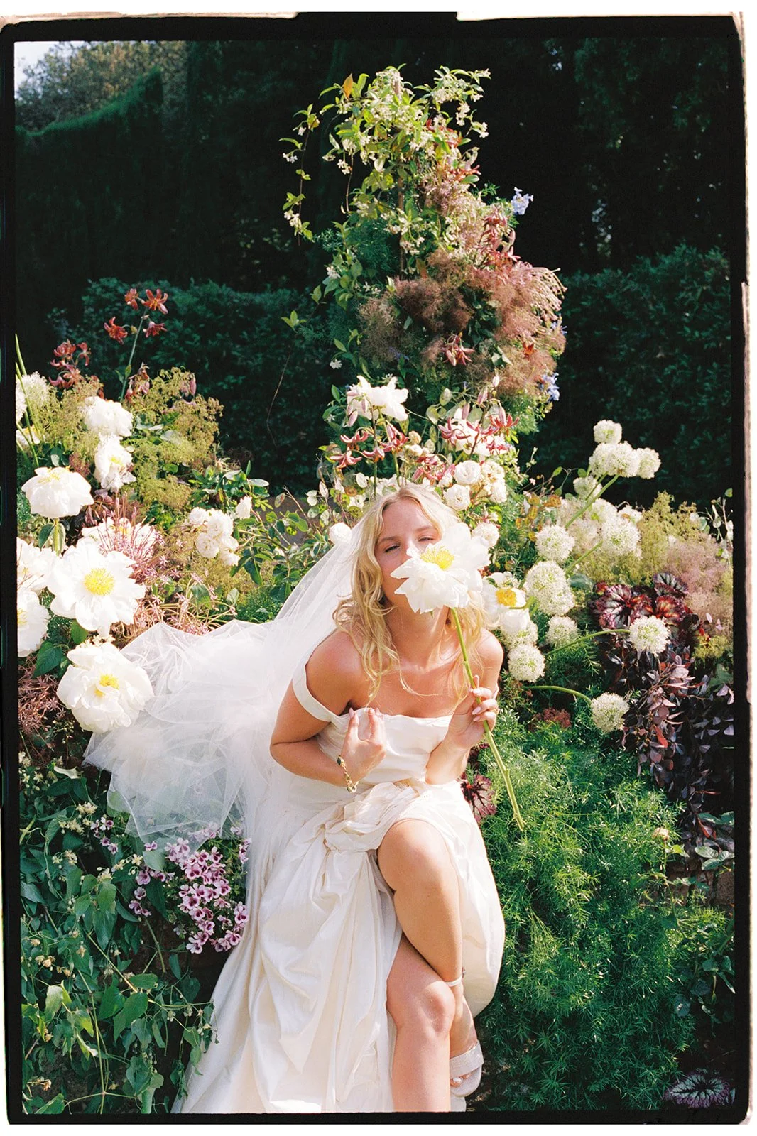 Bridal portrait in a floral installation in Italy