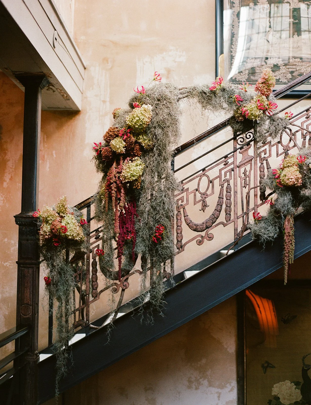 Floral installation cascading along a staircase railing