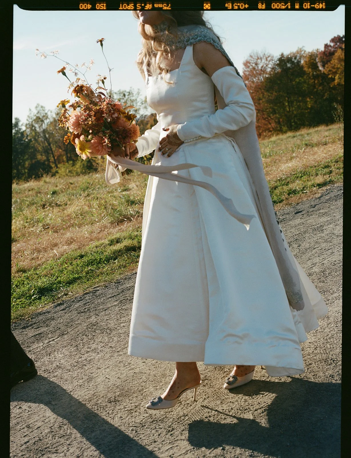 Bride carrying a bouquet outdoors