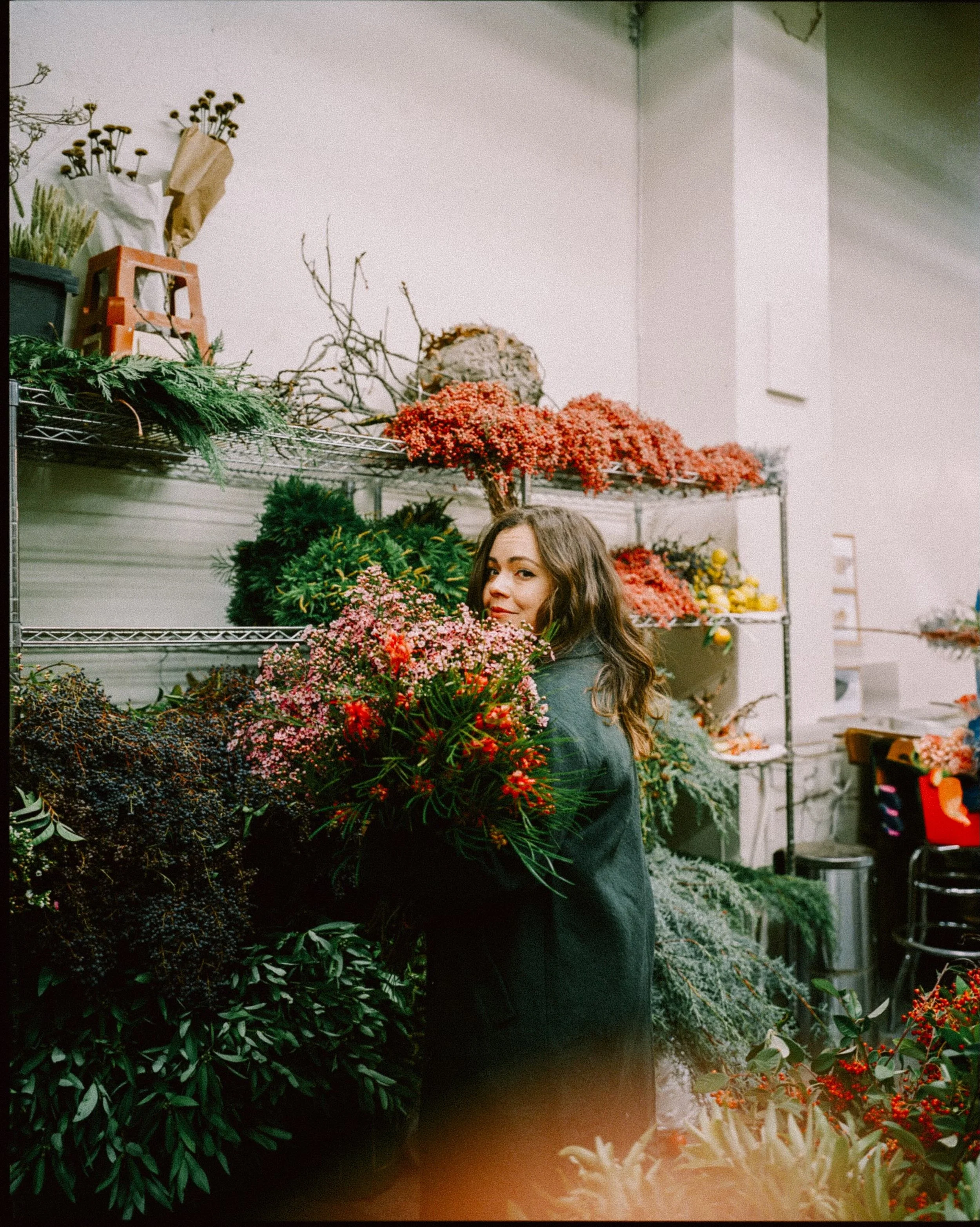 Floral designer carrying flowers at the market