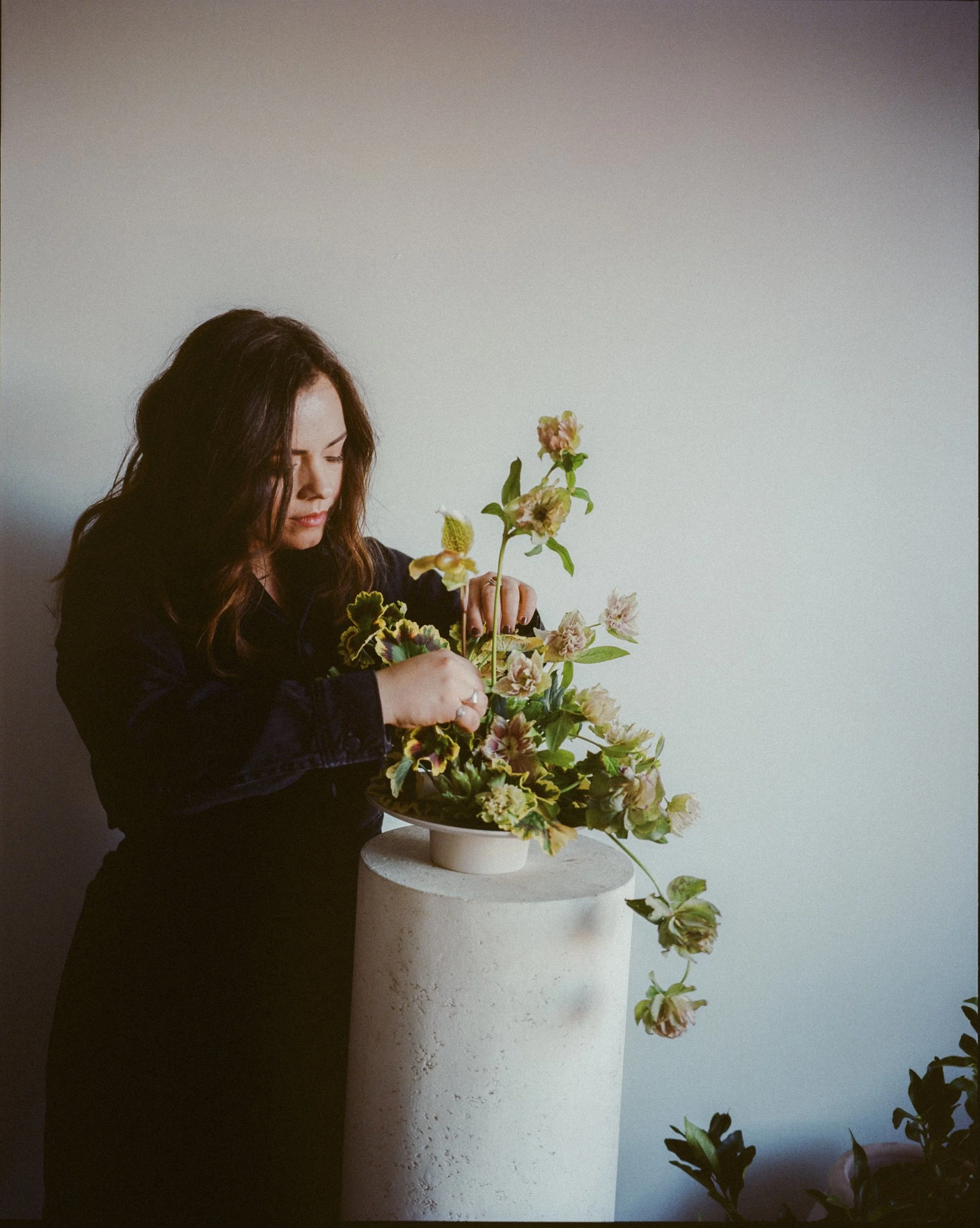 Tasha arranging flowers in her studio