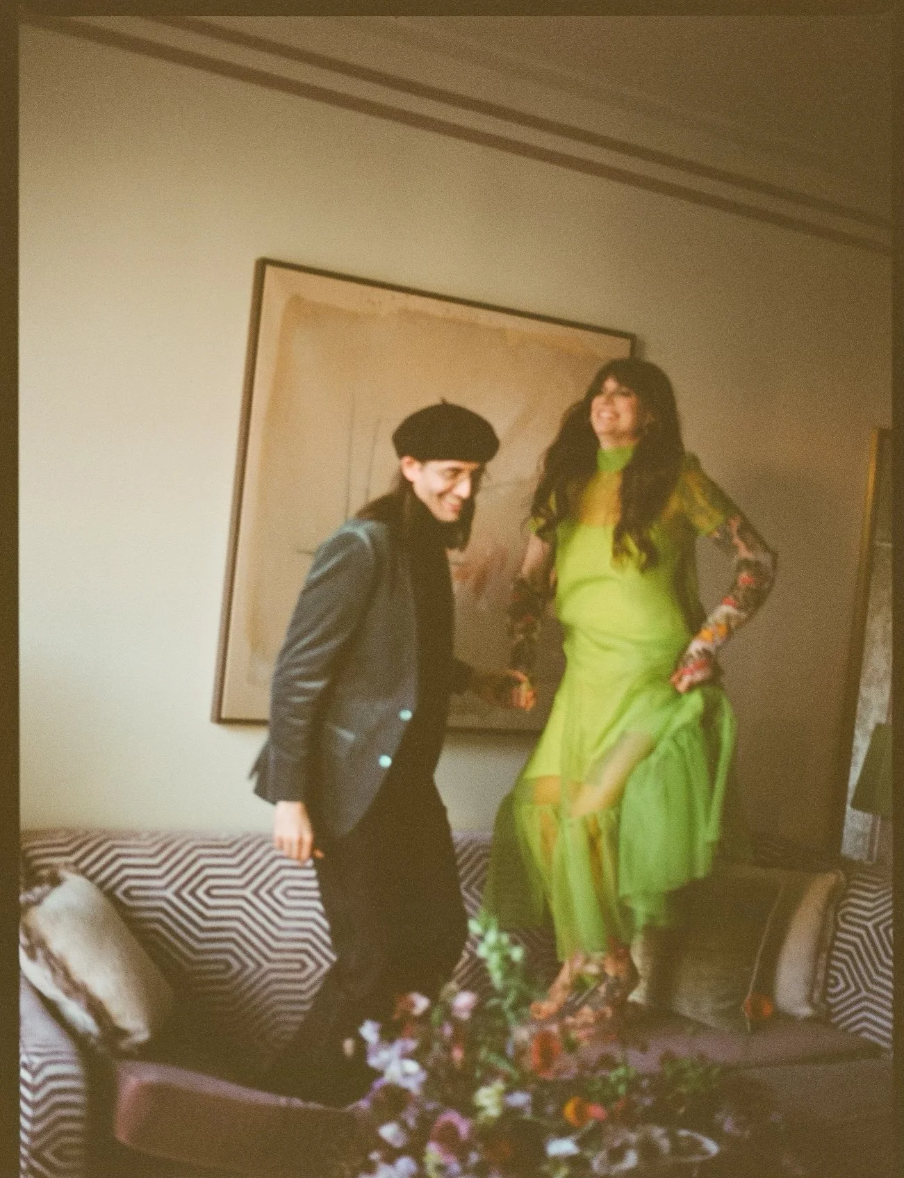Couple posing beside floral arrangements indoors