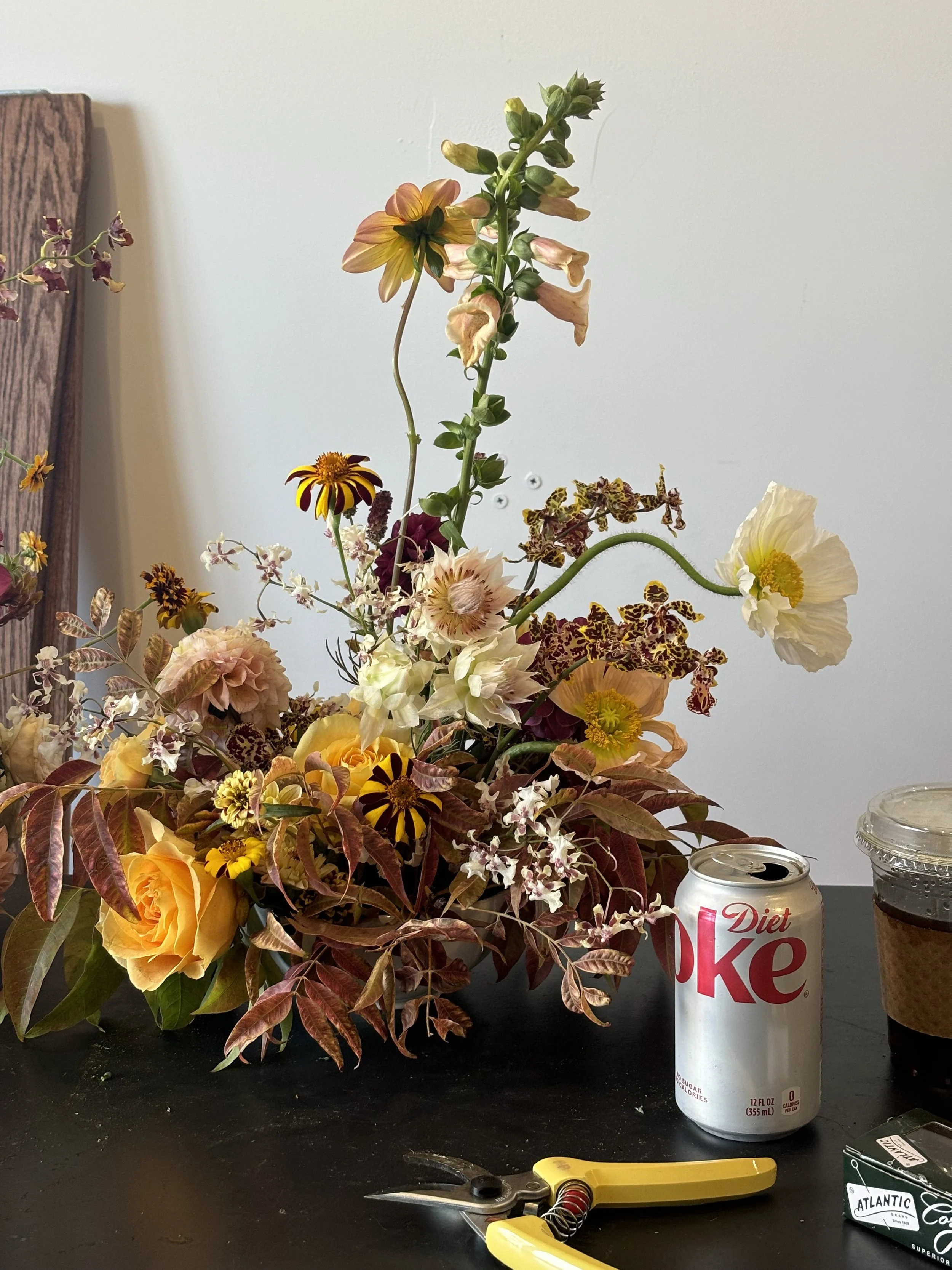 Floral arrangement in progress on a studio worktable