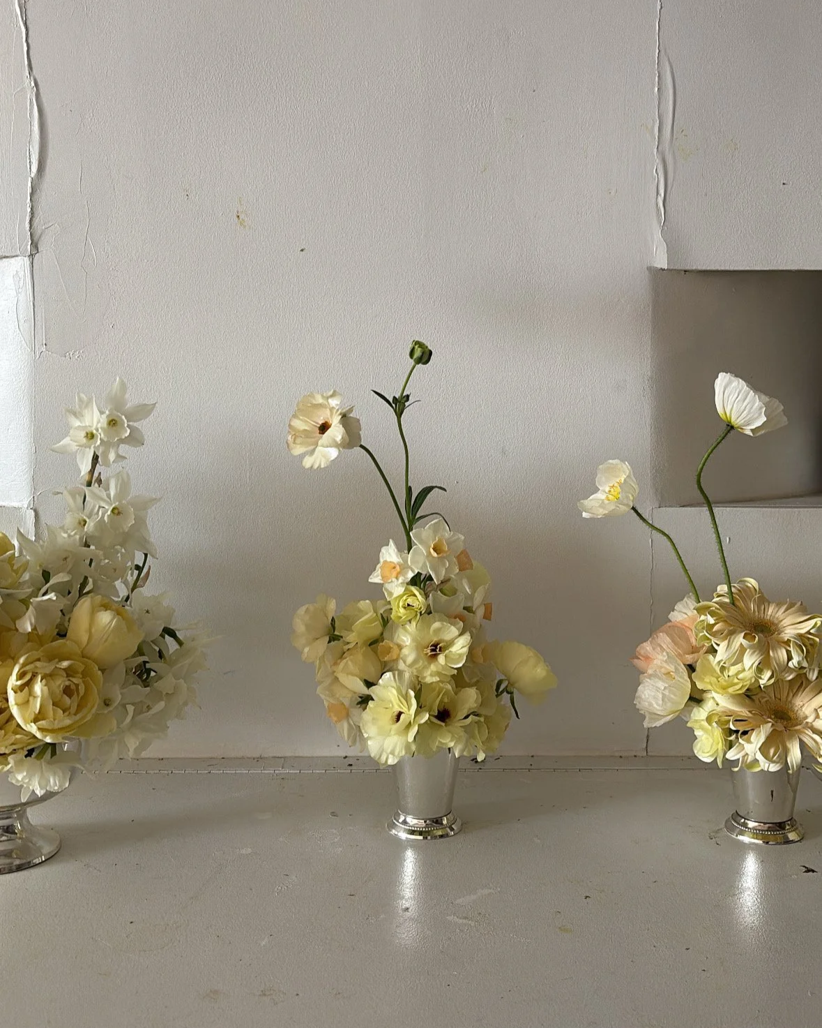 Modern floral arrangements featuring seasonal blooms displayed in a clean studio setting