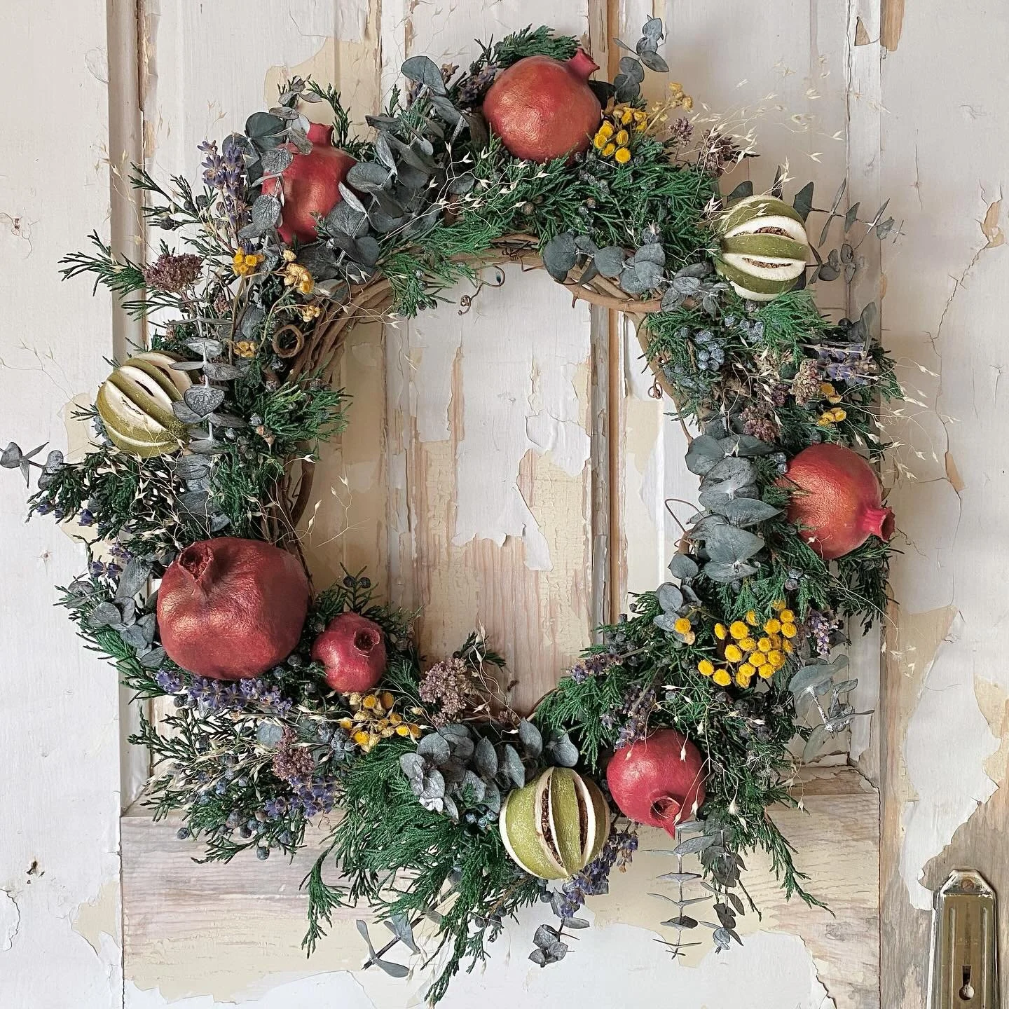 A favorite of the season! Featuring preserved juniper, eucalyptus, pomegranates, limes, oregano, lavender, tansy, and ricegrass - ships for free! ✨ 
.
.
.
#fruitandflower #flowershop #driedflowers #preservedflowers #naturaldecor #naturalwreath #dried