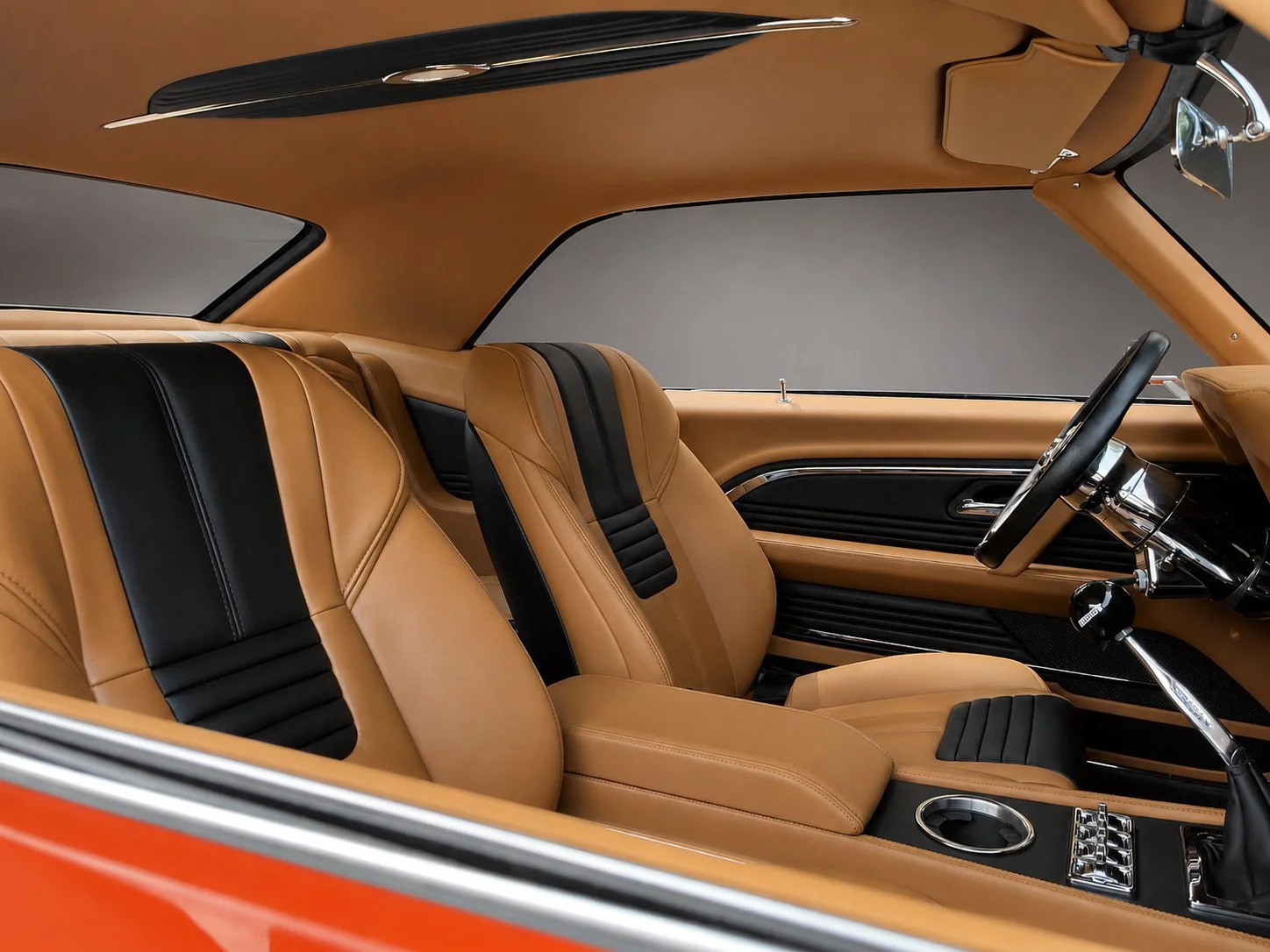 Full custom 1969 Chevrolet Camaro interior with tan leather seats, black accents, and a custom one-piece headliner.