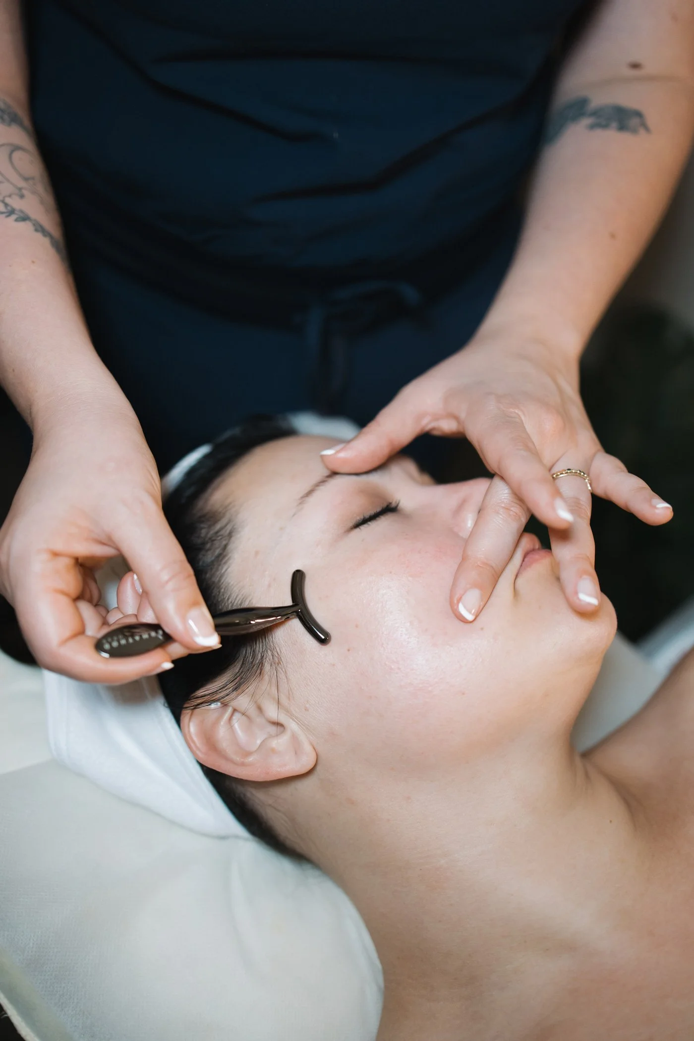 Person receiving a sculpting facial treatment, with a skincare tool used by holistic aesthetician, Lauren Staebell of Face & Forme Aesthetics, a holistic spa offering lymphatic drainage located in St. Louis Missouri in the Brentwood neighborhood