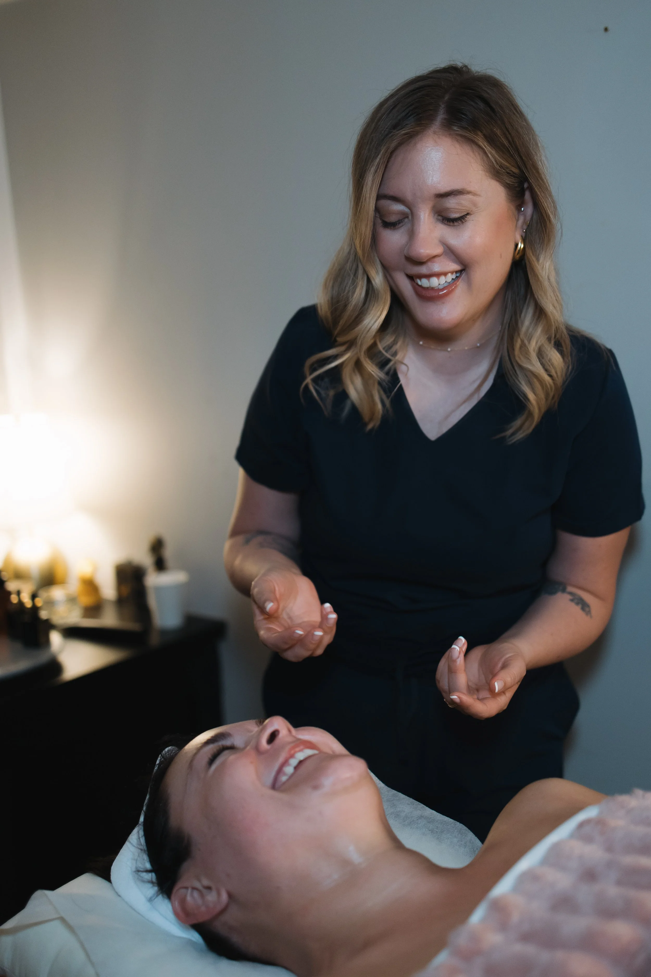 Esthetician at holistic spa in St. Louis with happy client during lymphatic drainage facial