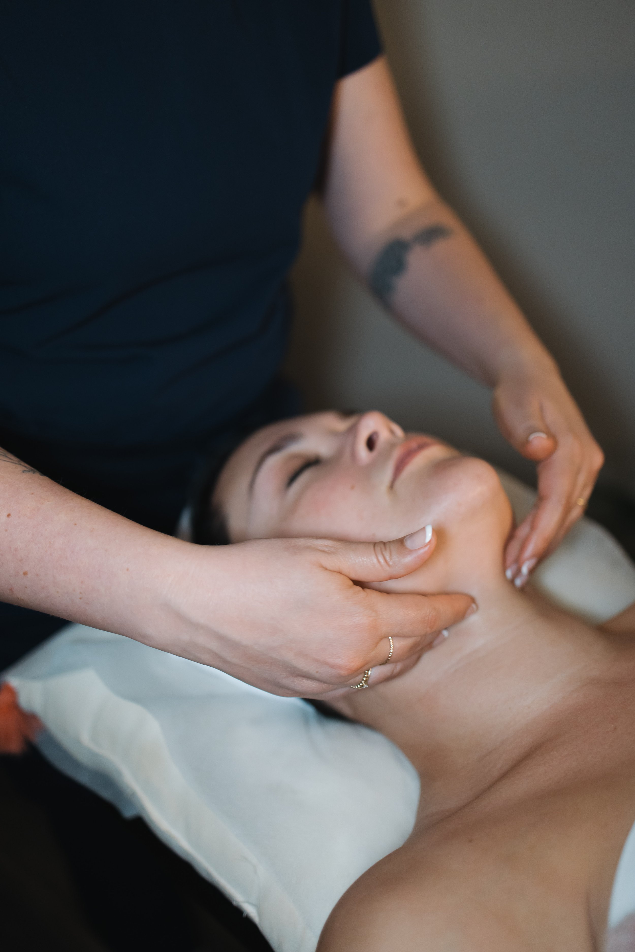 A woman receiving a lymphatic drainage facial in St. Louis, Missouri at a holistic spa located in the Brentwood area