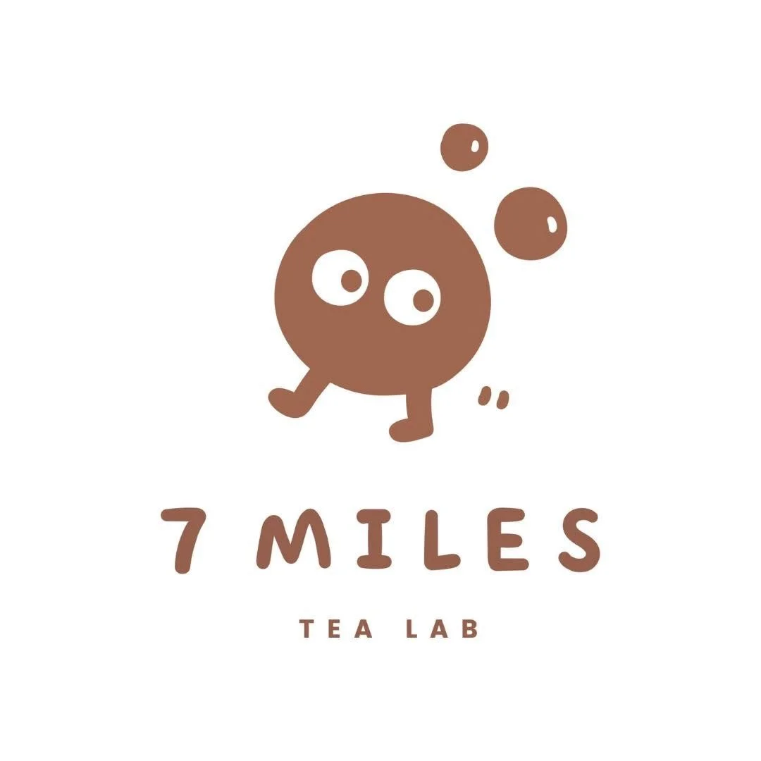 Logo of a tea brand called '7 Miles Tea Lab' featuring a cute cartoon character with a round brown body, big eyes, and bubbles or steam rising from its head.
