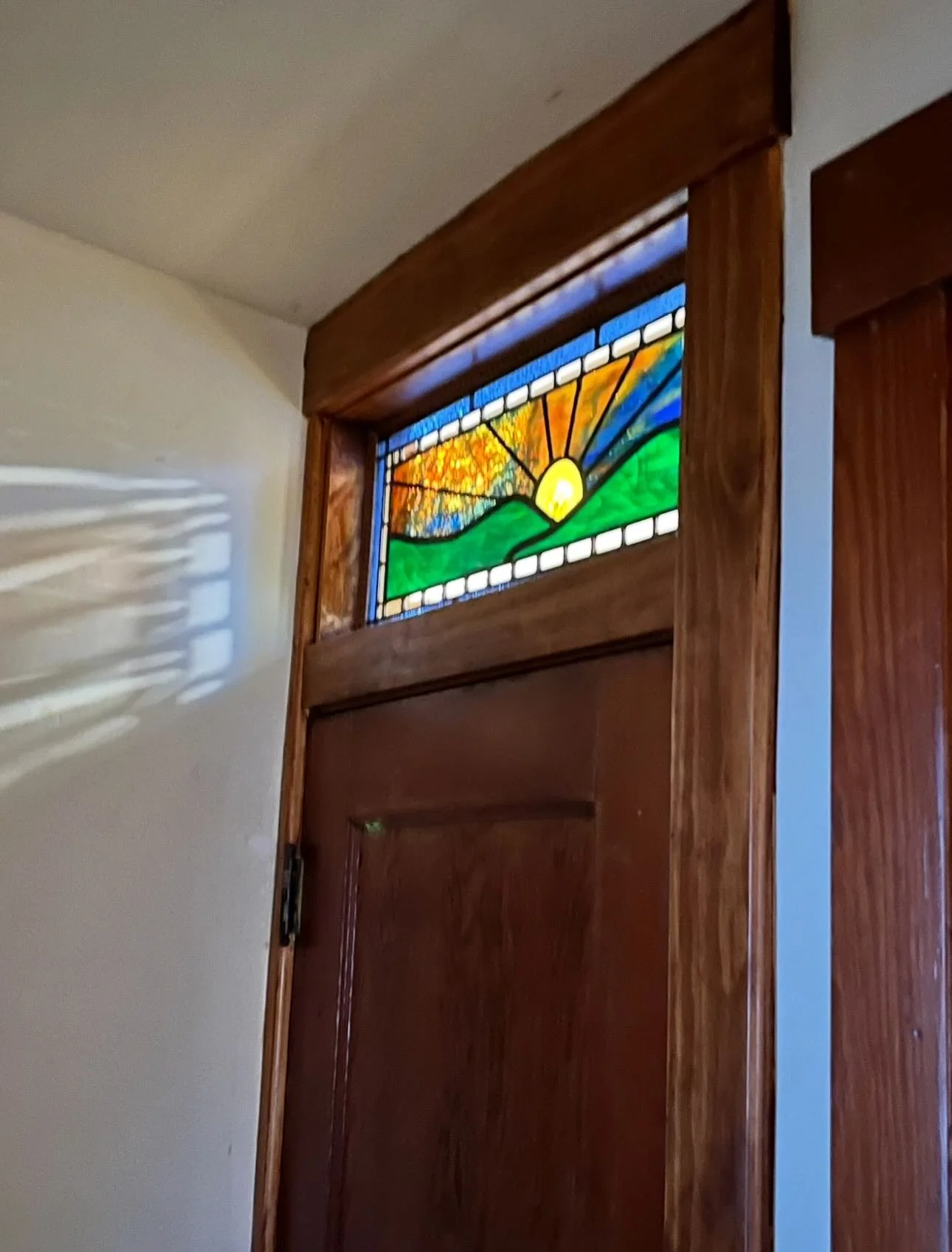 Before and after: My client sent me this photo of their remodel all finished &mdash; and seeing my stained glass transom in its new home just made my day! #beforeandafter #stainedglass #stainedglassart #homerenovation #interiordetails