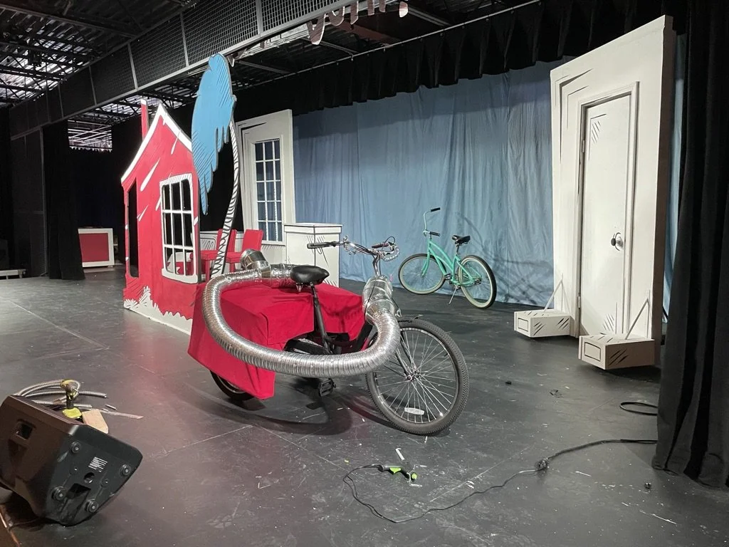 Pictured here is the Cat in the Hats Picking up machine, crafted out of an adult tricycle and plastic totes. The goal was not to hide the fact that it was a tricycle.