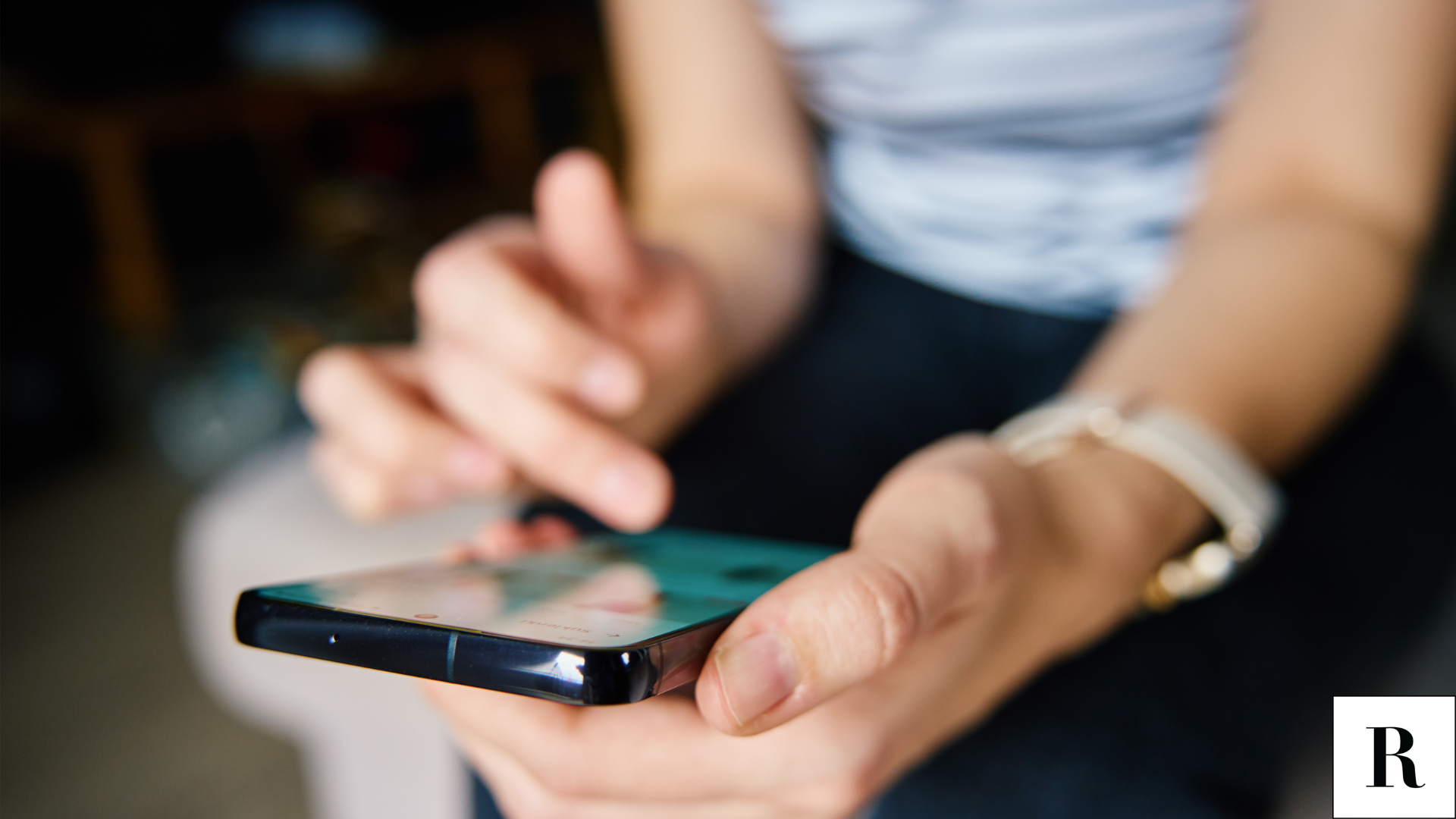 A closeup image of a woman searching on her phone