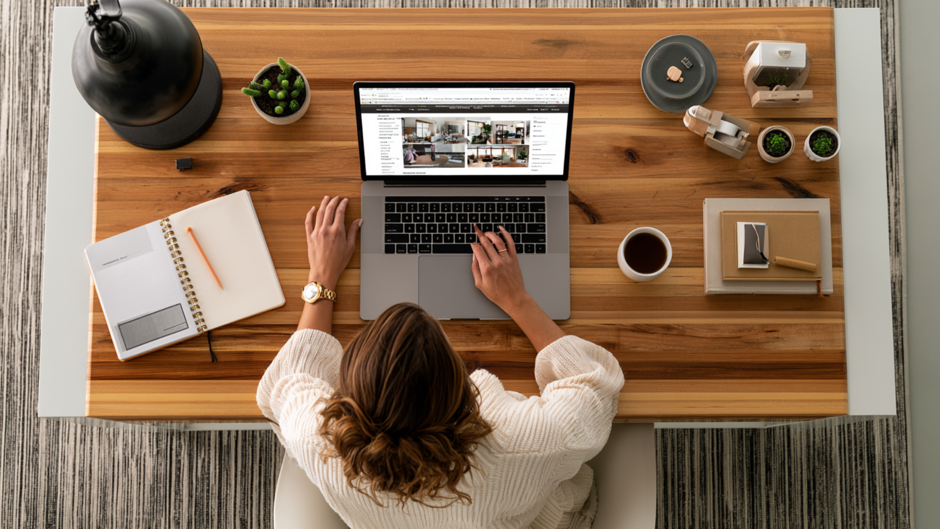 a female business owner sitting in front of her laptop at a desk working on her website