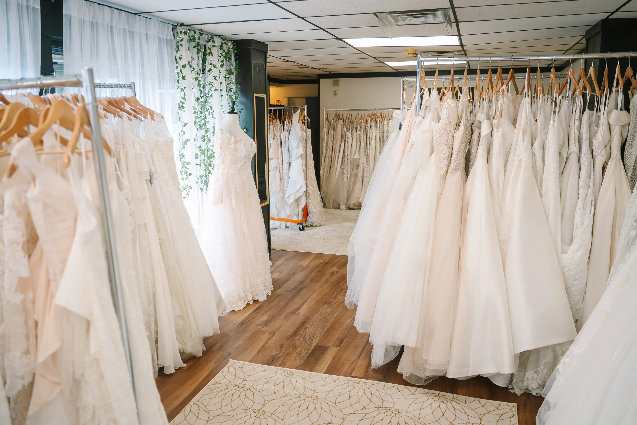 Bridal shop interior showing racks of gowns