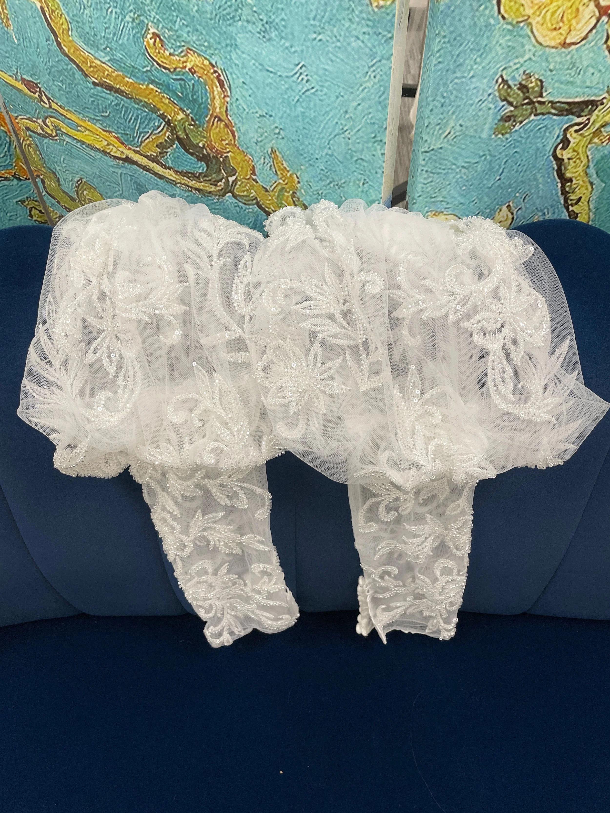 Sleeves: Detachable leg of mutton sleeves with beading