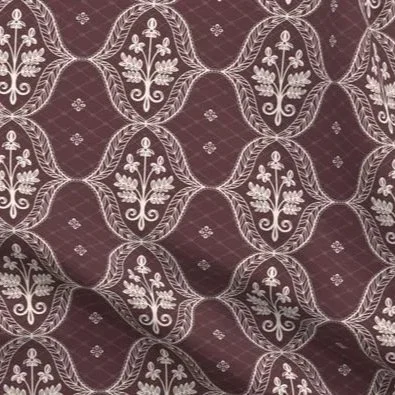Close-up of ornate lace diamond medallion fabric in burgundy and cream