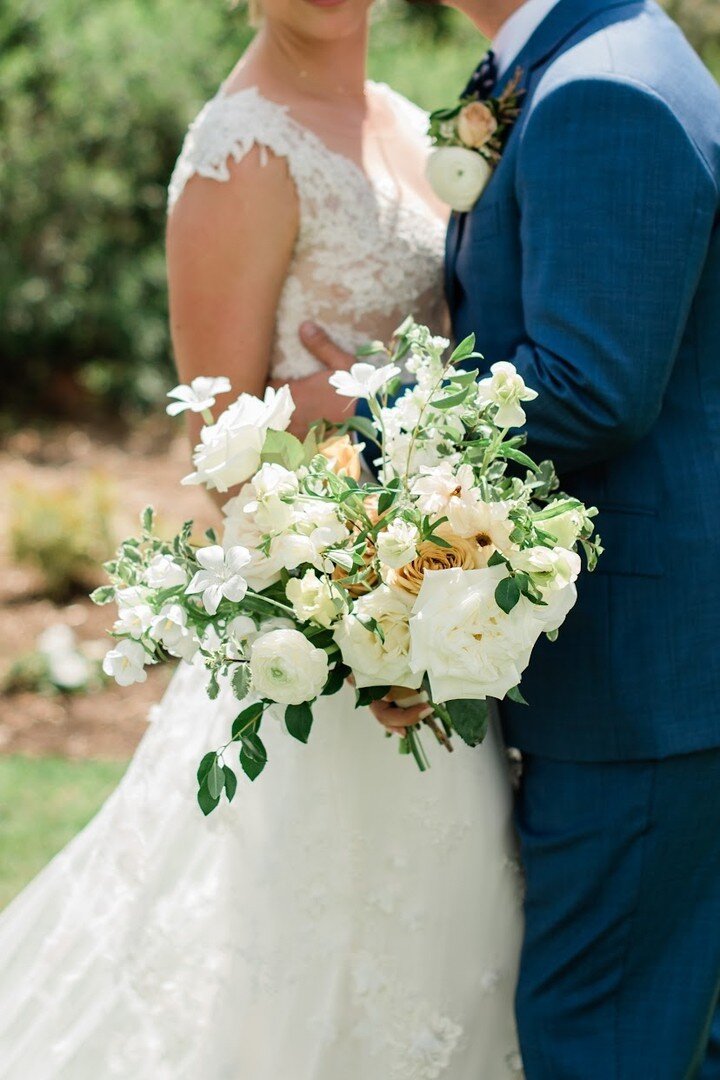 Lauren's asymmetrical, naturally-shaped bridal bouquet was arranged with large-headed flowers with high petal counts, creating a substantial yet soft feeling in the bouquet, and accented by fluttering white blooms, delicate textures, and fresh foliag
