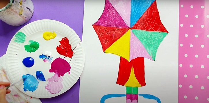 girl painting a colourful umbrella