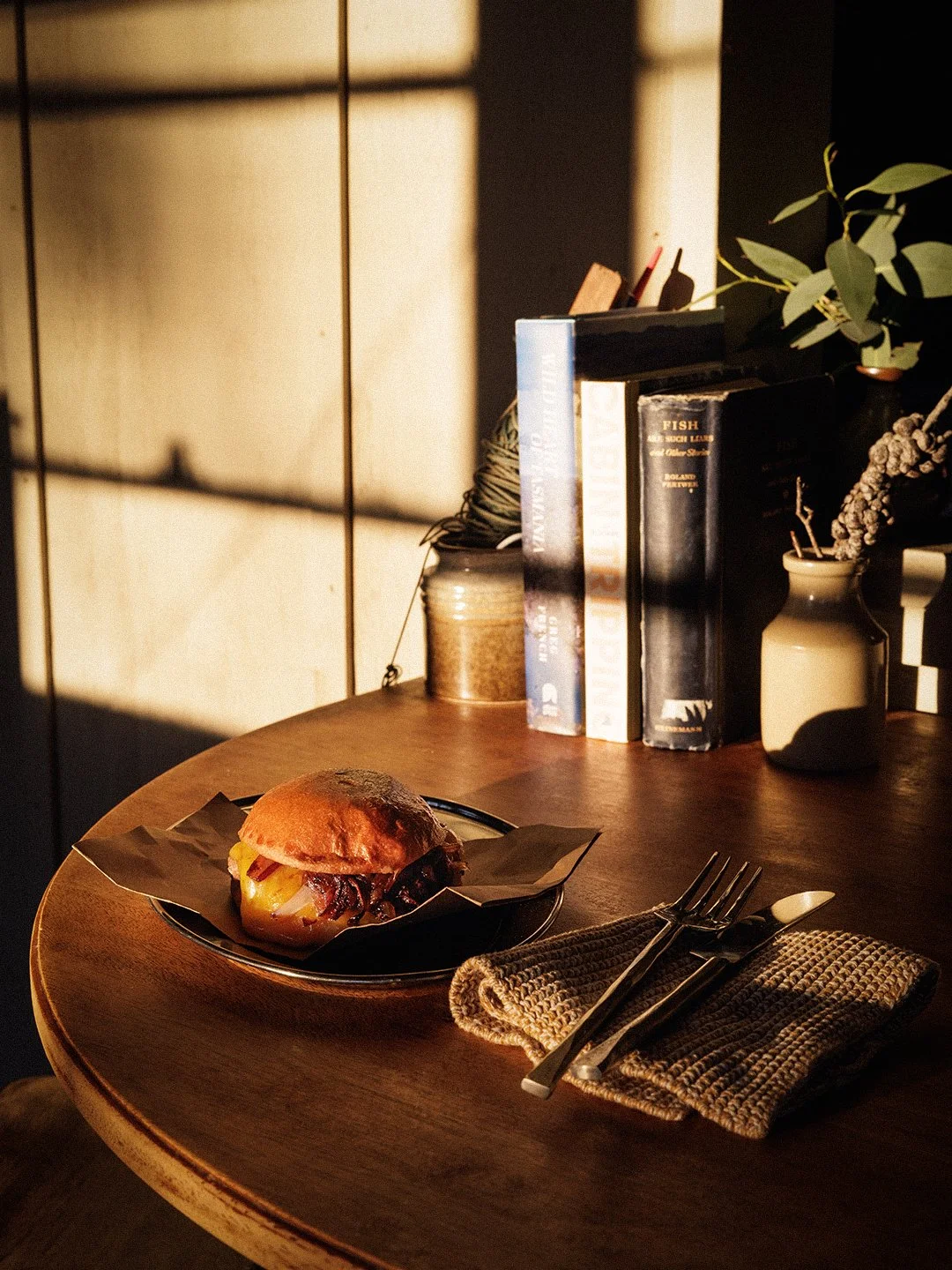 hamburger on a table with afternoon light streaming through a windo
