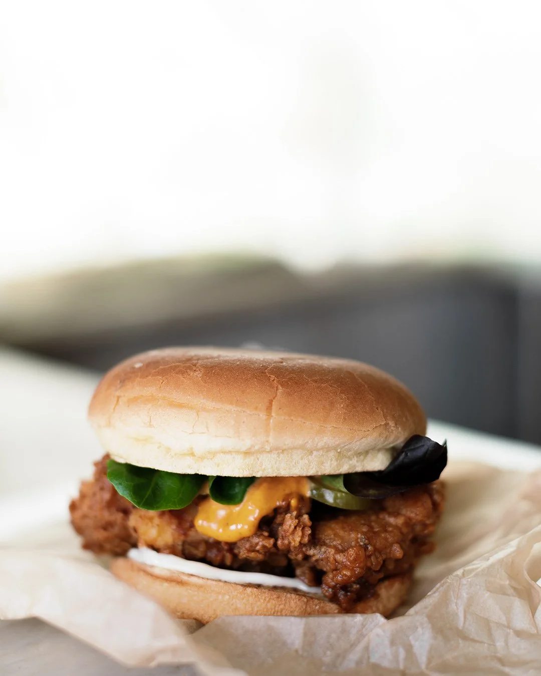 CHICKEN BURGER with Crispy Skin, Slaw &amp; Hot Sauce