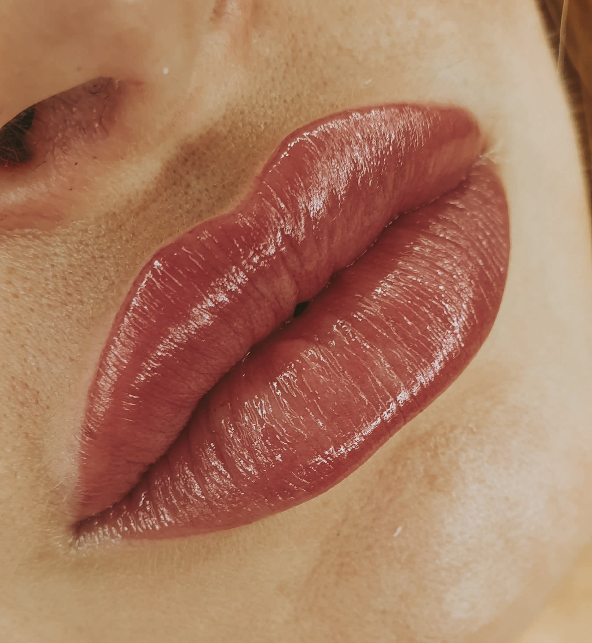 close up of red colored lips that had lip tinting treatment done