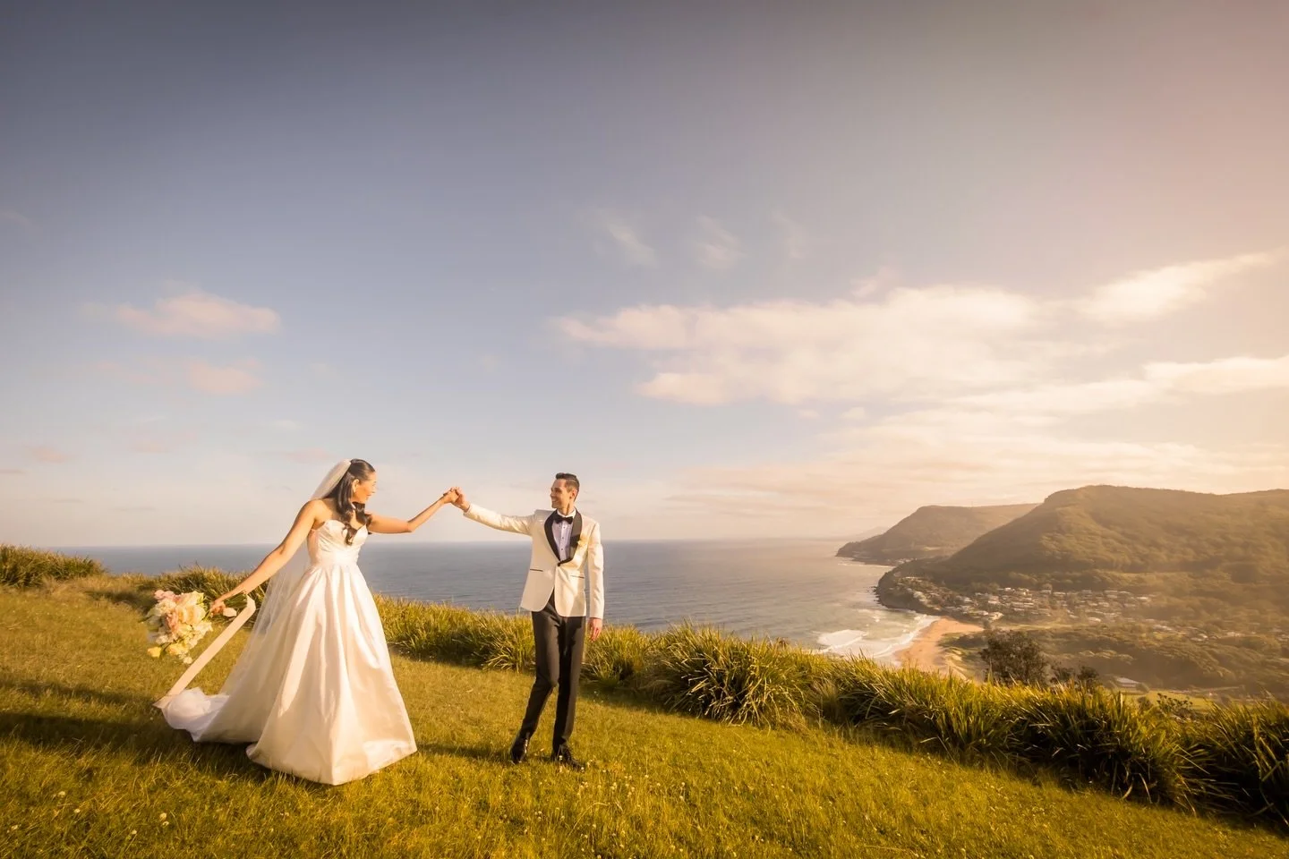 Golden hour at Stanwell Park really knows how to show off.
We had about 10 minutes of perfect light &mdash; just enough time for a quick spin, a bit of laughter, and one of those &ldquo;this is why we love photographing coastal weddings in Sydney&rdq