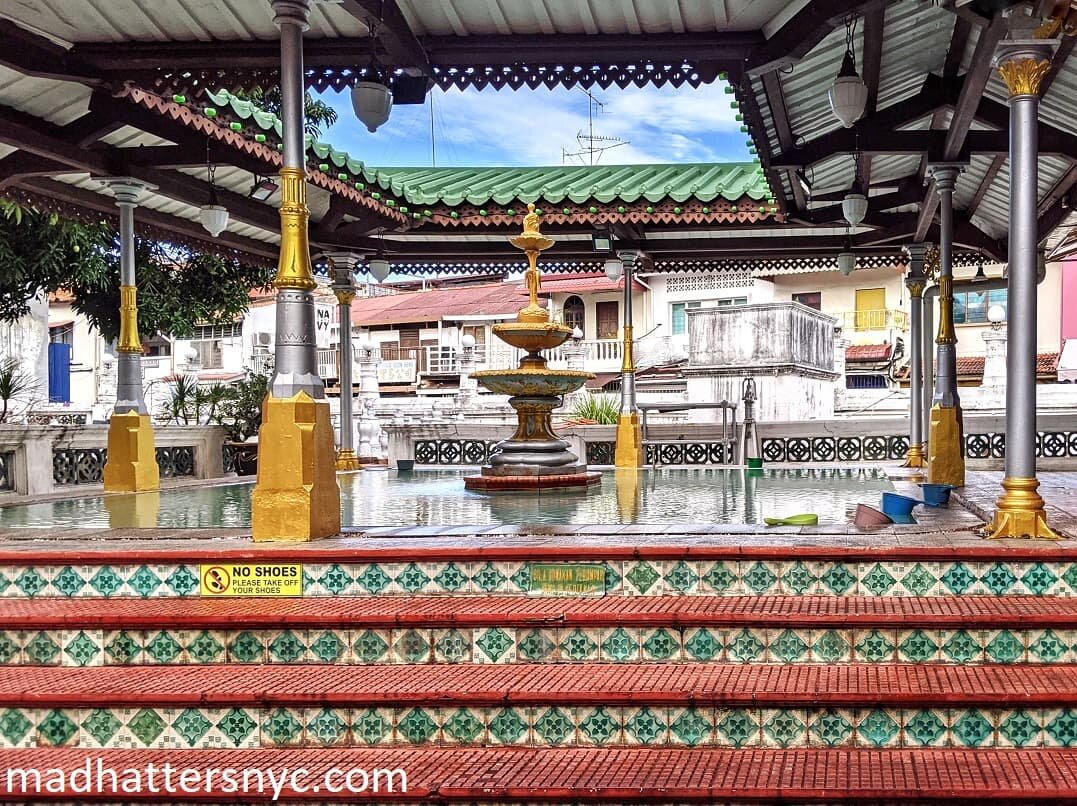 Ablution pool with ornamental columns and fountain with steps leading up to it at Kampung Kling Mosque in Melaka, Malaysia