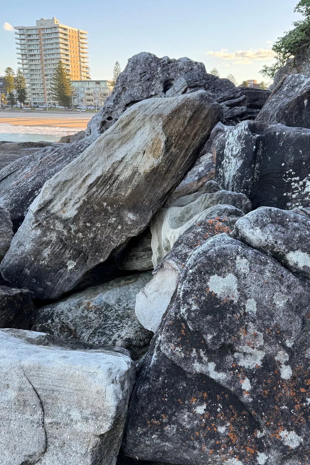 A heart on a rock with Manly Beach in the background.