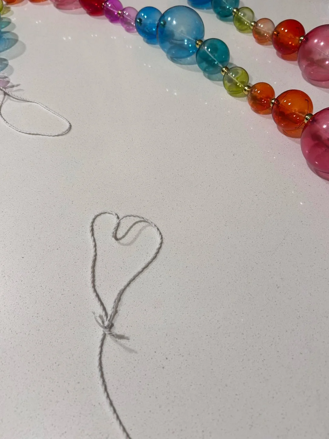 "A string heart shows up as I hang a rainbow garland for my New Year’s Eve party." - Brittny Goodsell of Washington