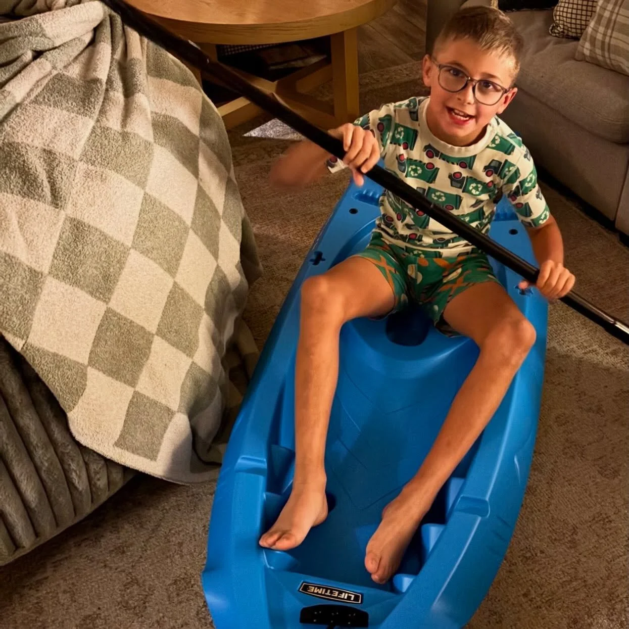 It was 6 am sharp! on a school day and Cowboy had already somersaulted out of bed and was paddling among the pillows and throws in the family room in the kayak we gave him. 
.
When we called to sing Happy Birthday, loud and off key, we had to switch 