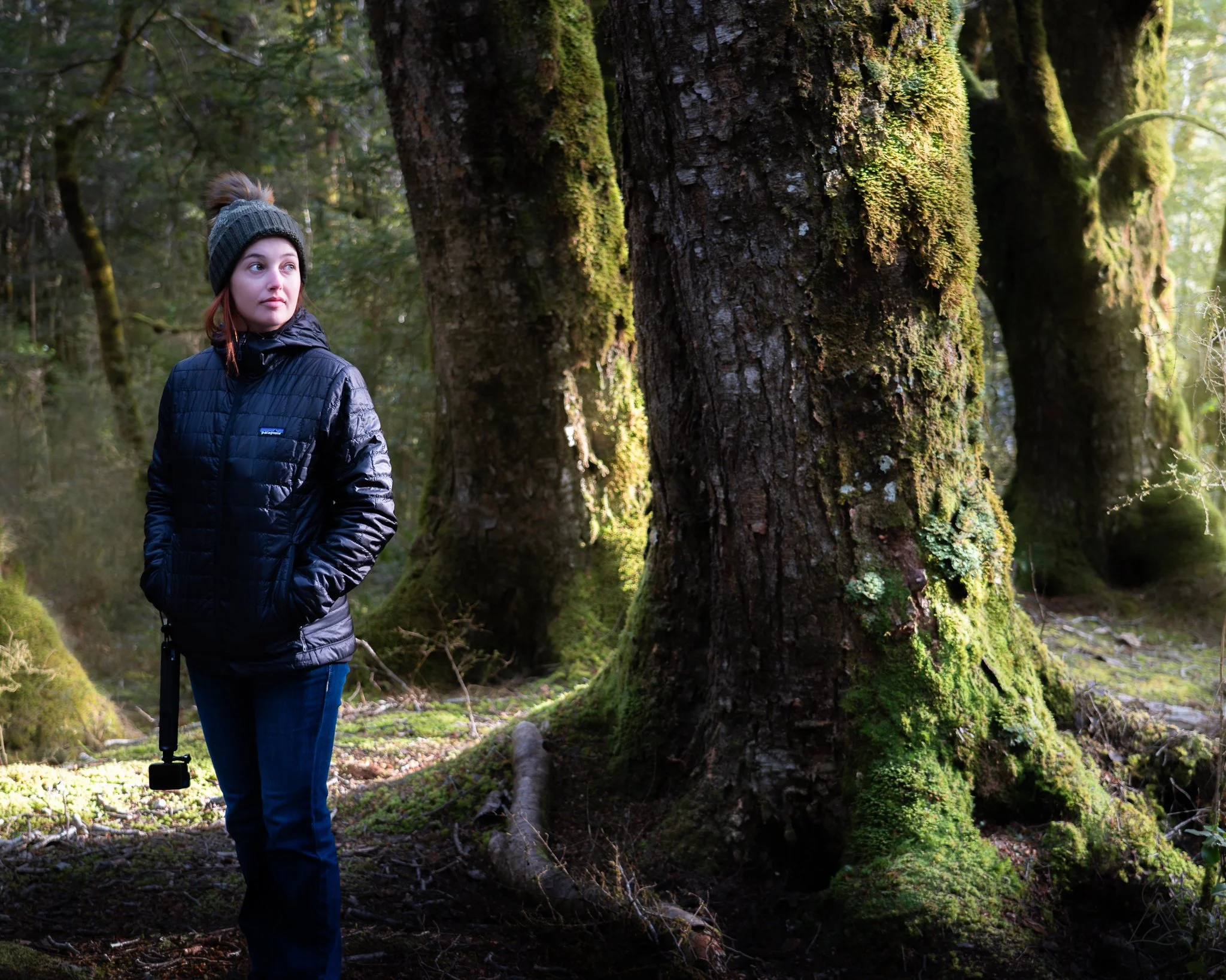 A photo of Rochelle next to a tree, taken on a hike in New Zealand.