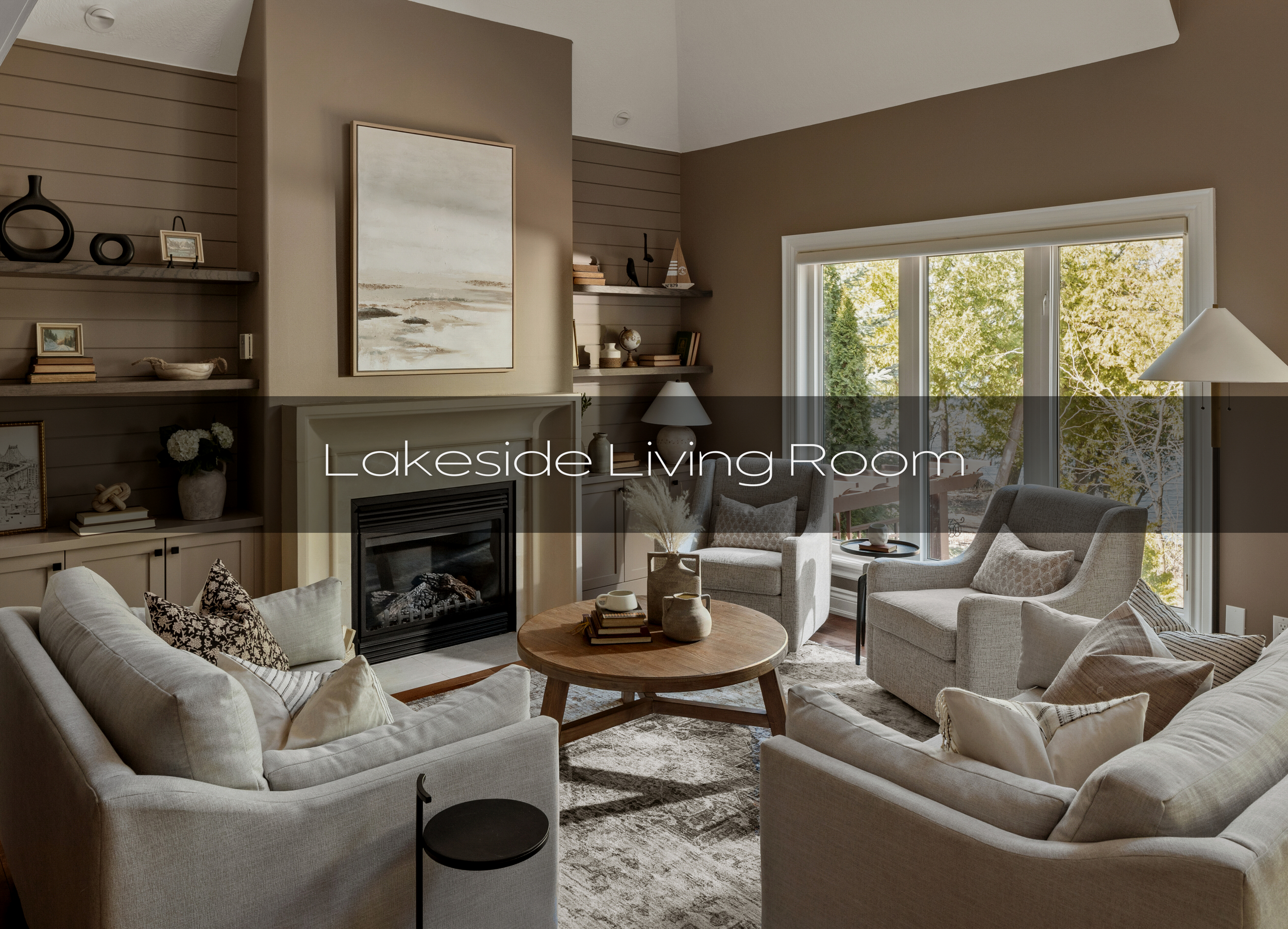 Lakeside living room featuring neutral furnishings that were custom made to suit the space. The fireplace wall features a custom fireplace surround.