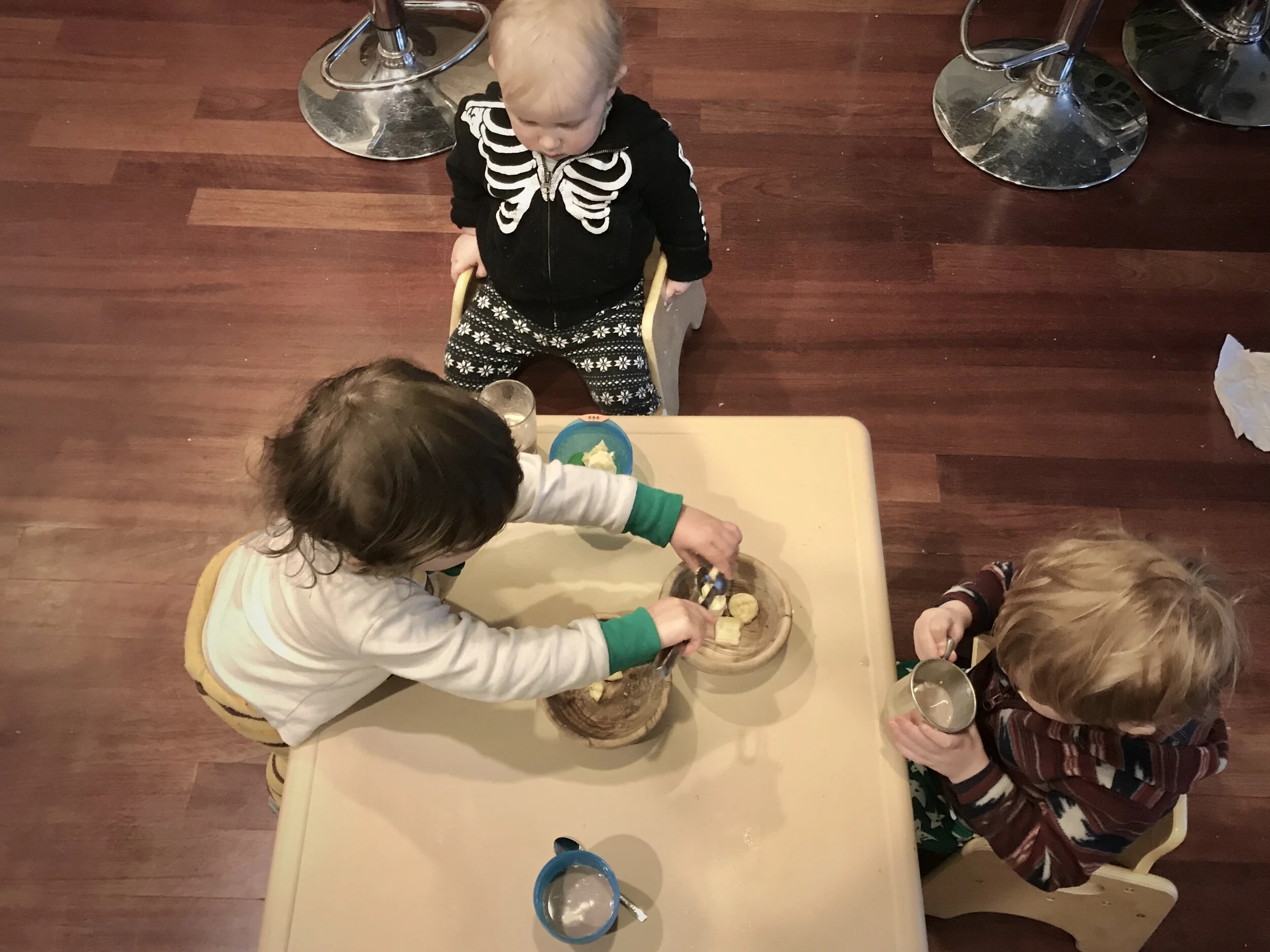 Providing a small table and chairs supports independence for young toddlers.