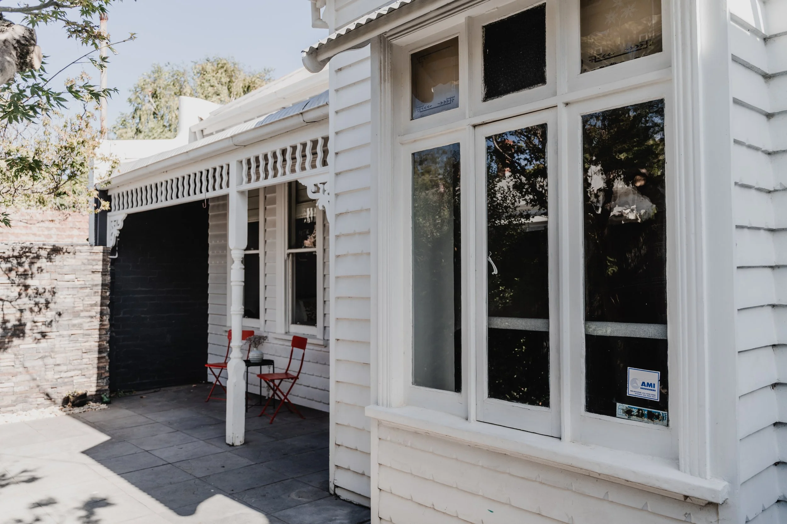White weatherboard cottage with verandah on Charles Street St Kilda