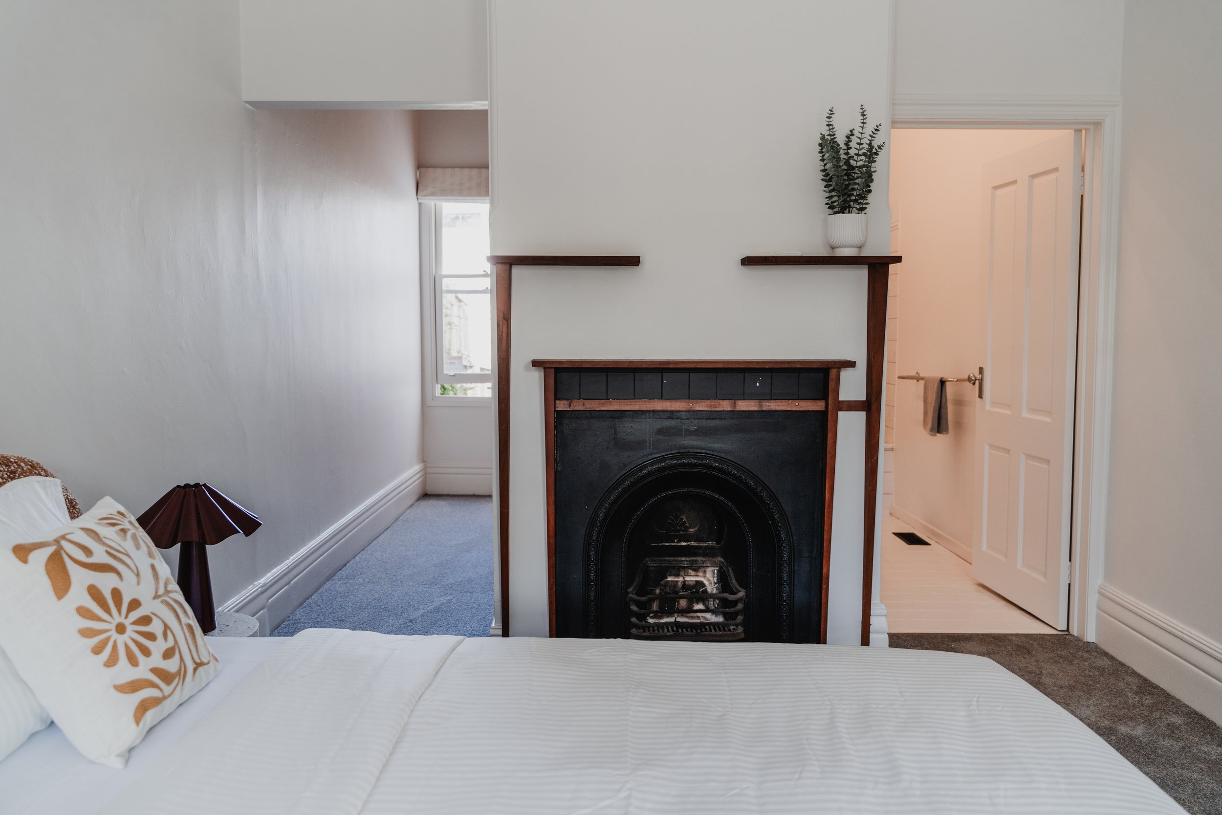 Original cast-iron fireplace in St Kilda weatherboard cottage