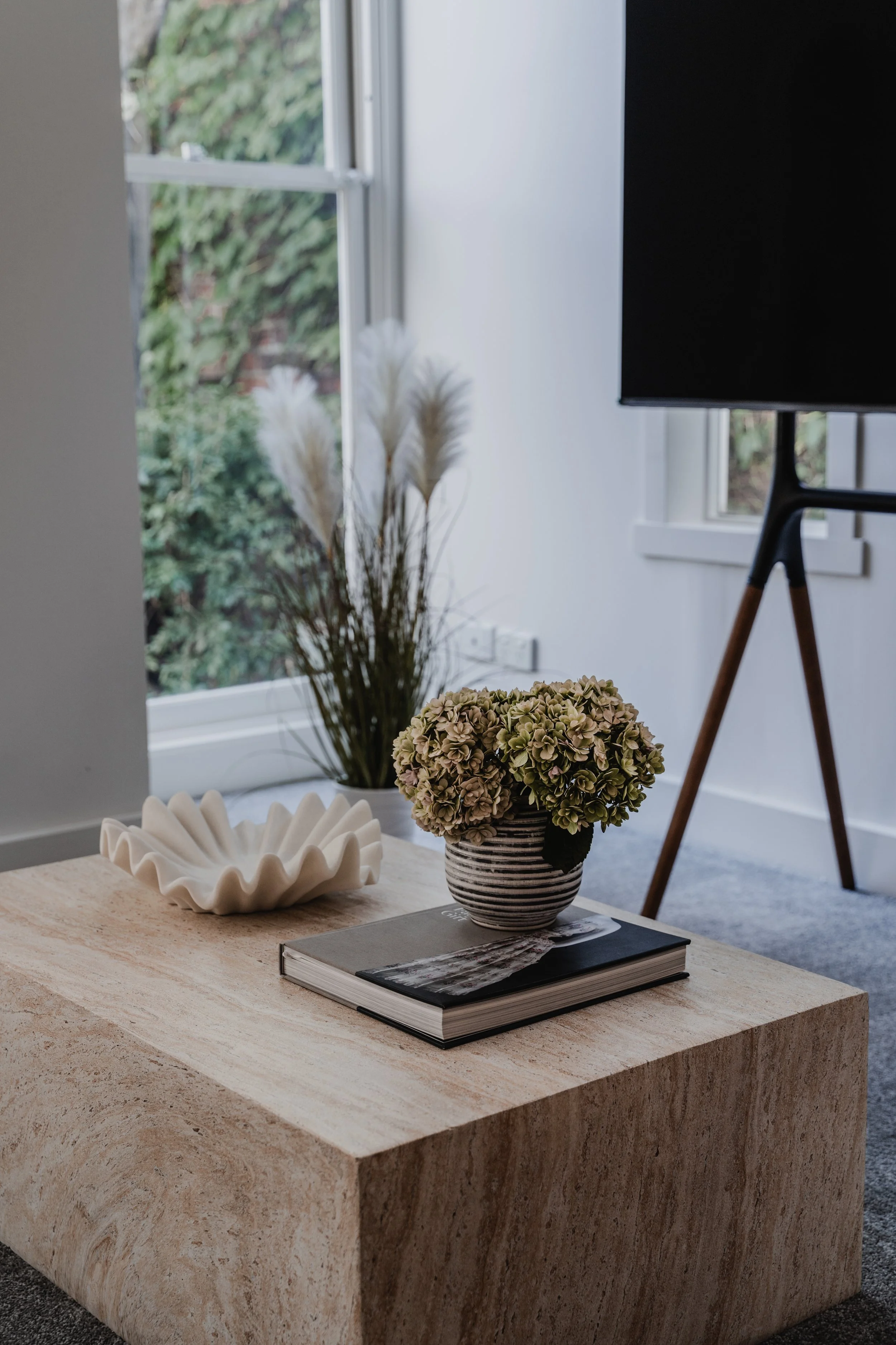 Travertine coffee table styled with dried flowers in St Kilda Airbnb