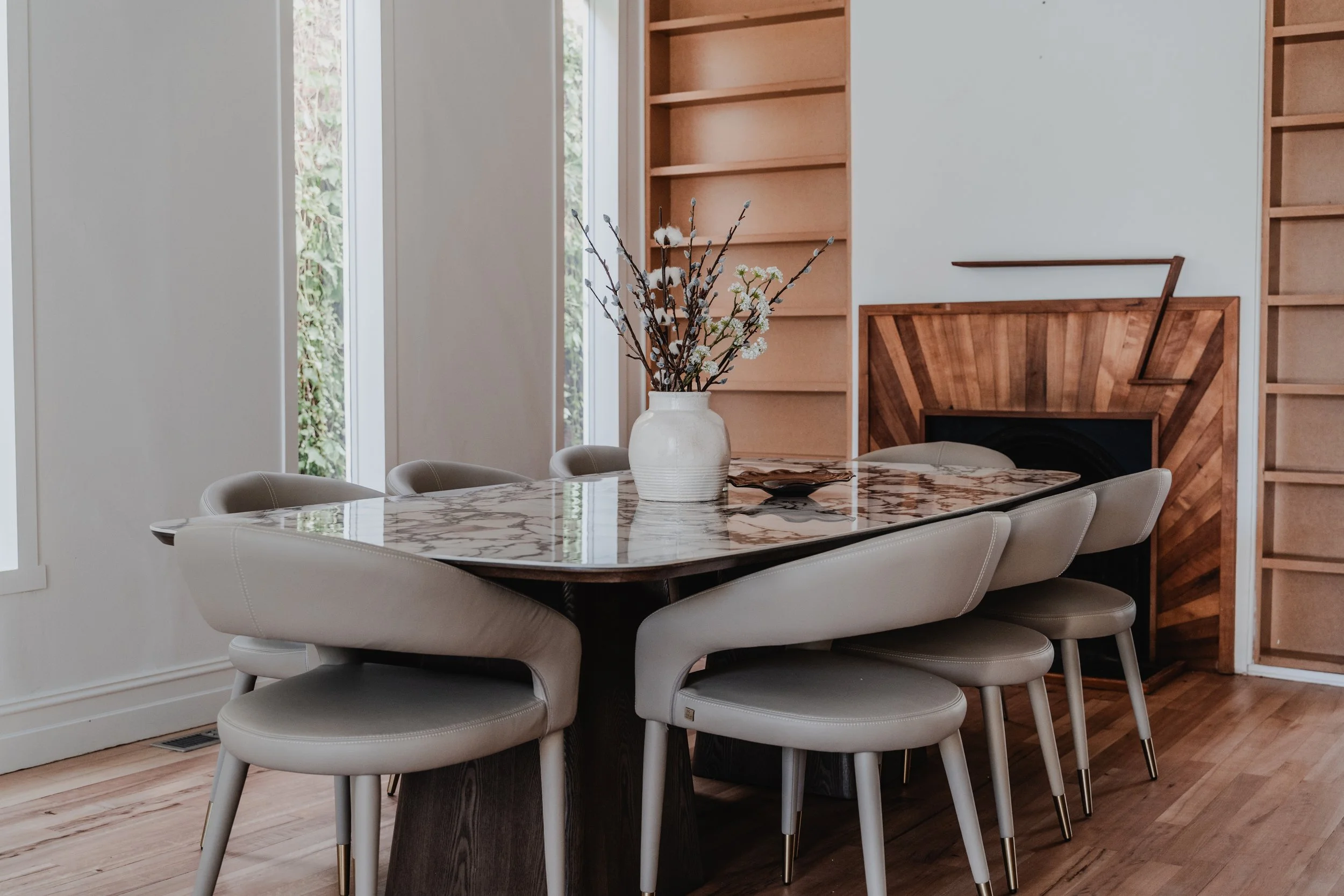 Marble dining table with cream chairs in St Kilda short-stay cottage