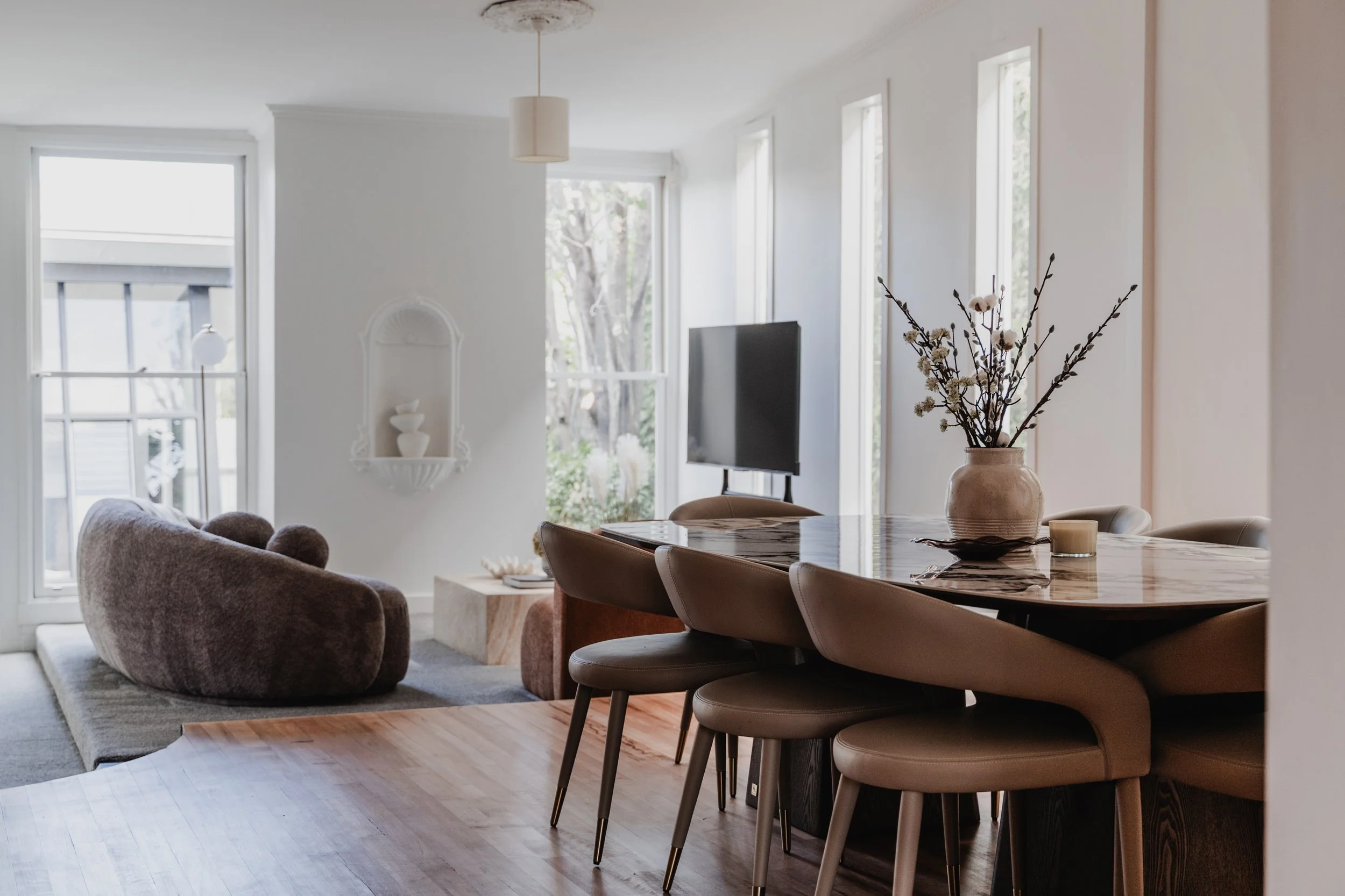 Open-plan dining area with timber floors in St Kilda Airbnb cottage