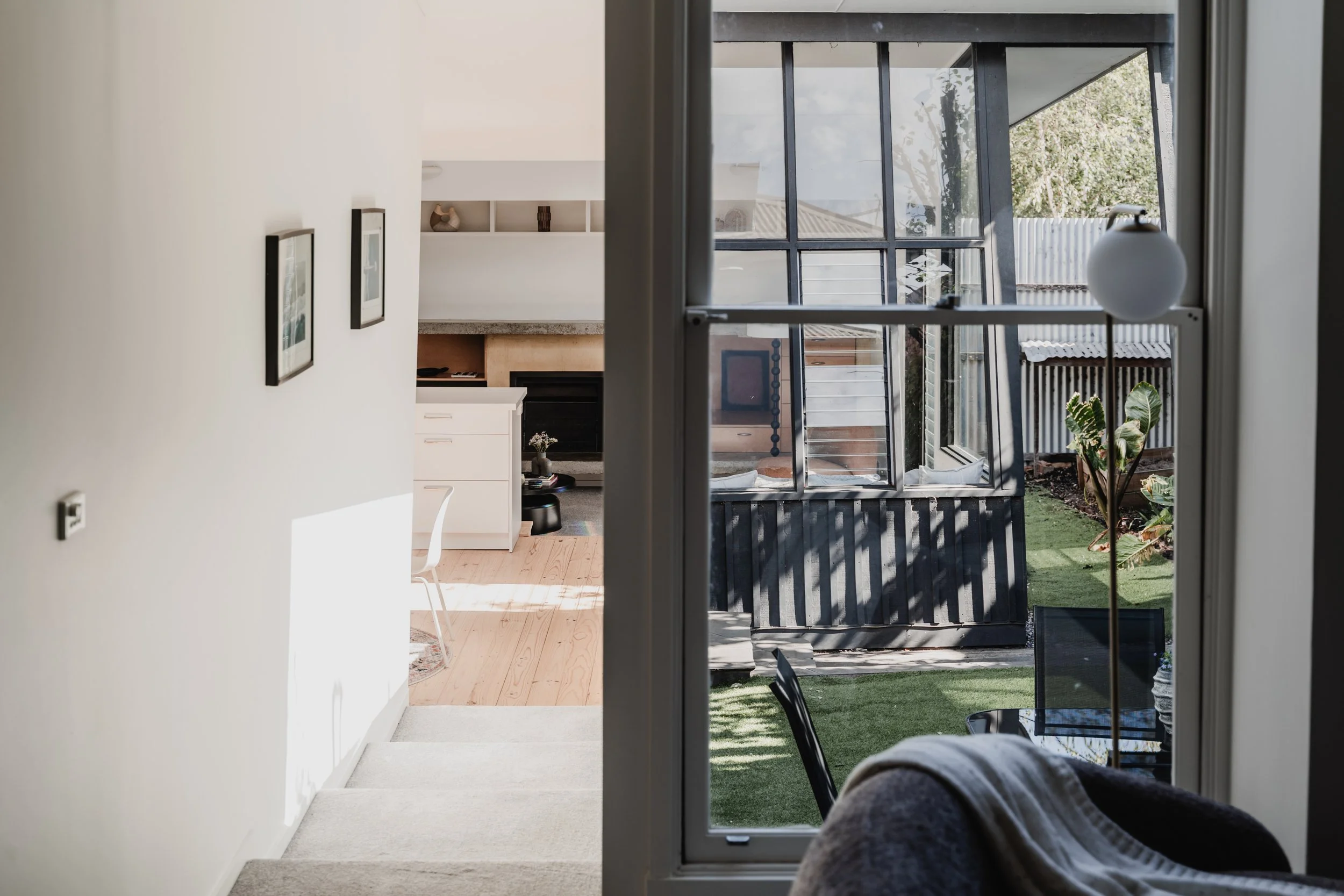 View from garden doorway into open kitchen of St Kilda Airbnb cottage