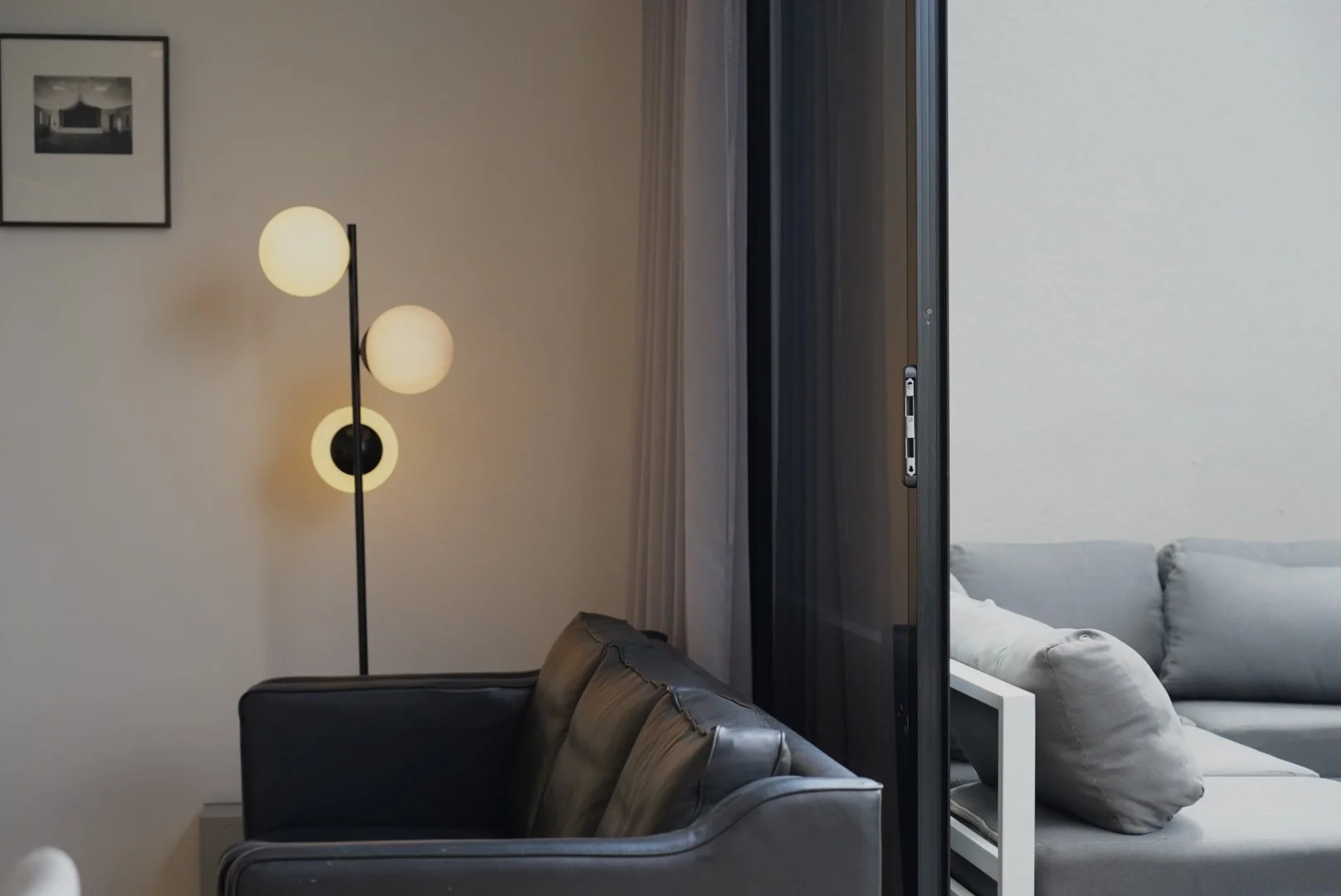 Leather armchair and curtains in Collingwood short-stay apartment