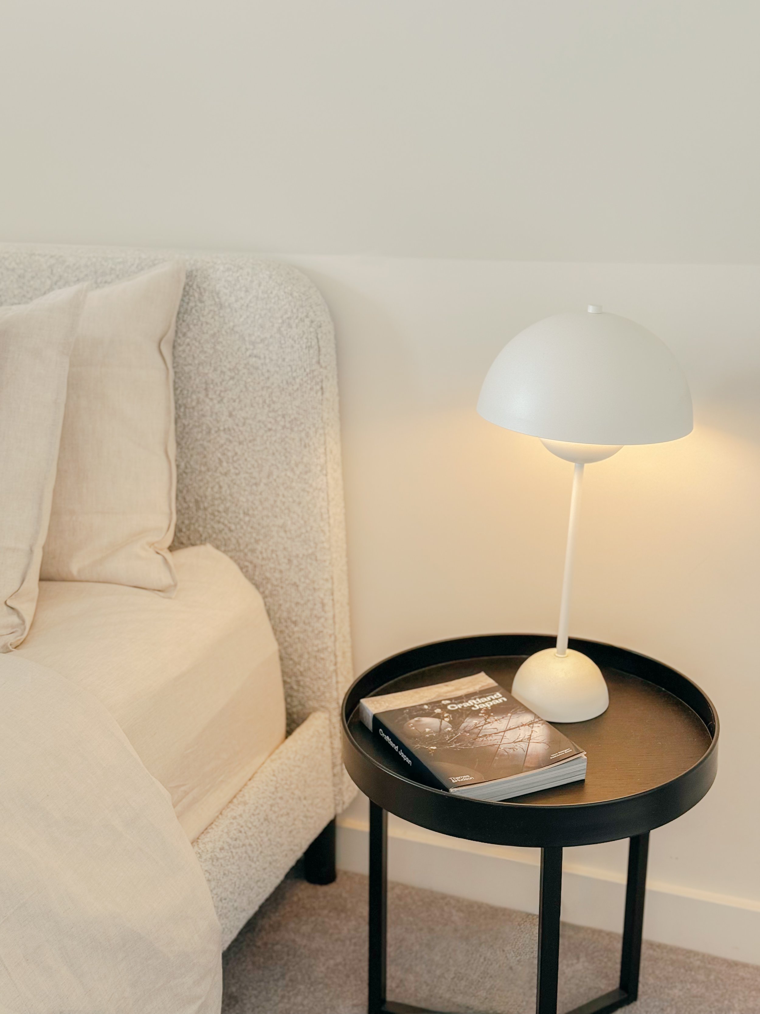 Styled bedroom with lamp and textured bedhead in Collingwood Airbnb