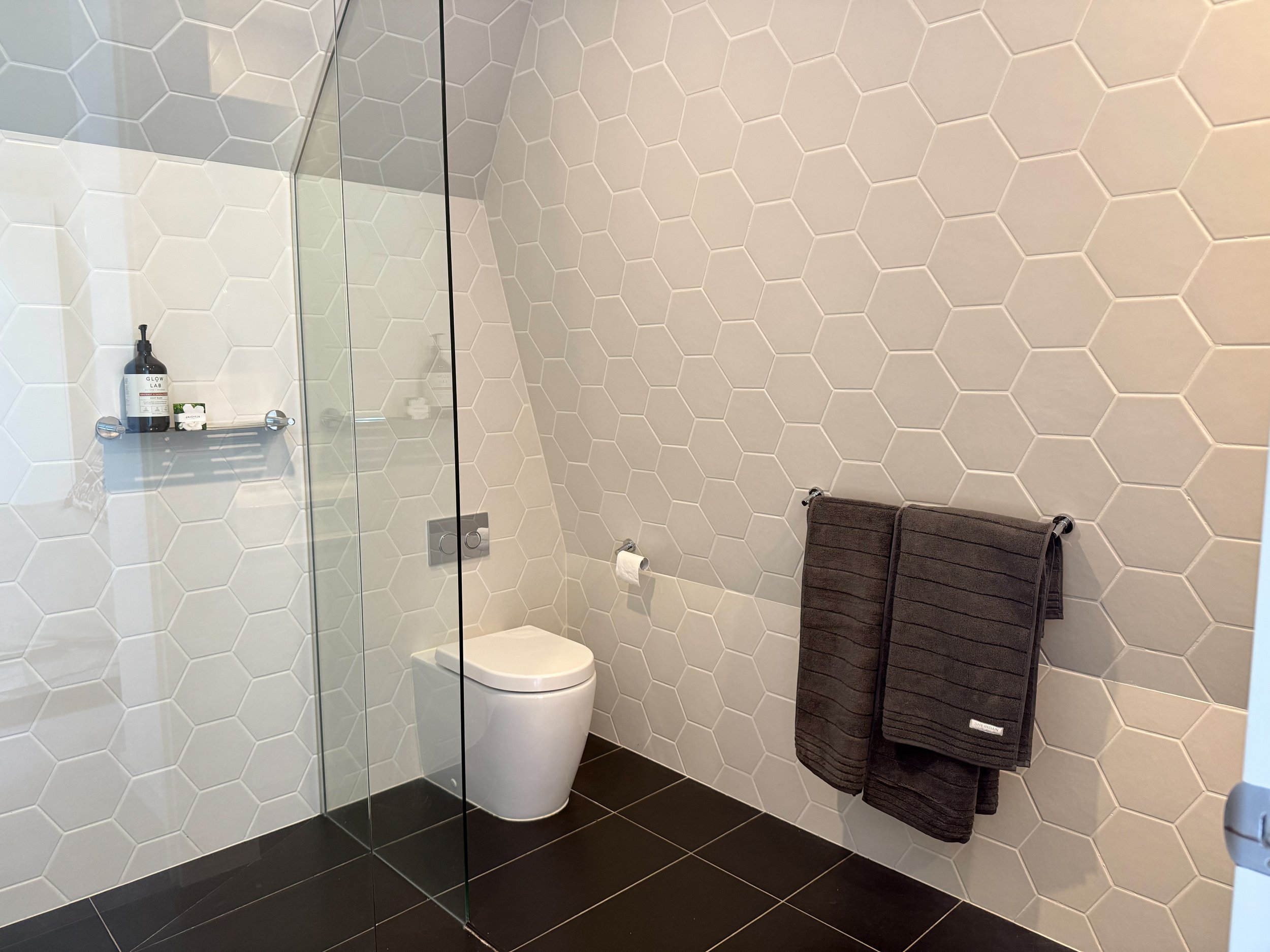 Bathroom with hexagon tiles in Collingwood Airbnb apartment