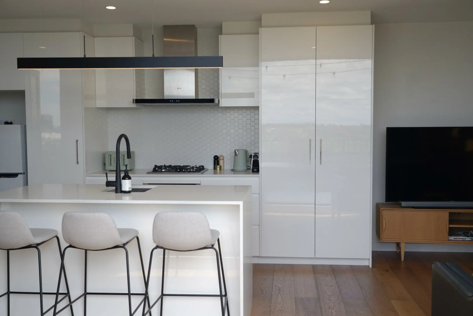 Kitchen with white cabinetry and hexagon splashback in Collingwood Airbnb