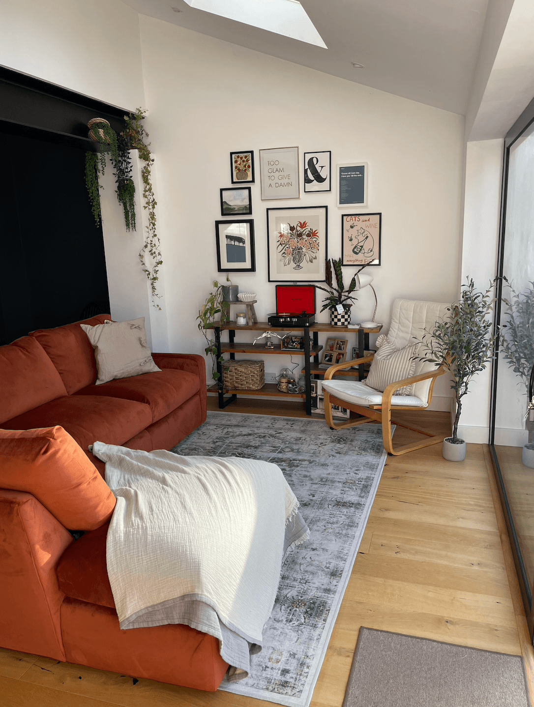 Open plan room with large corner terracotta sofa