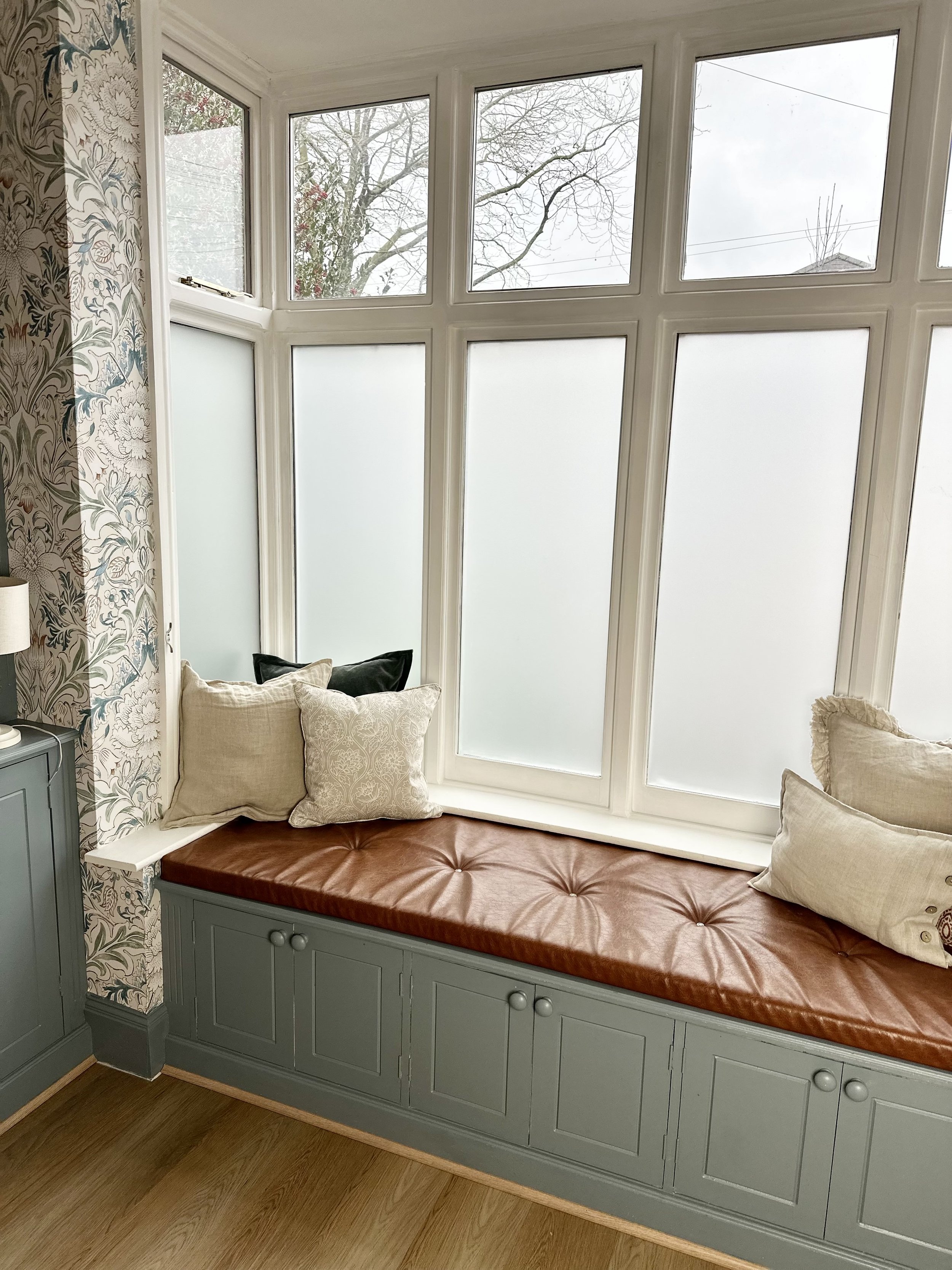 Bay window seat with built in storage and William Morris wallpaper