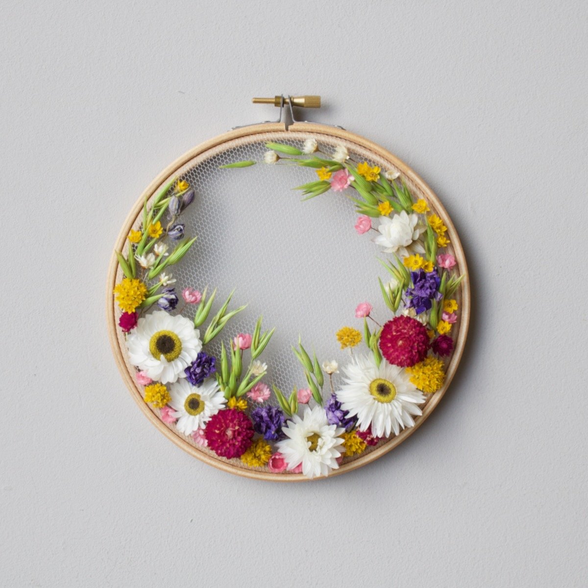 olga prinku embroidery on tulle kit number 2 on wall in collaboration with dried and floral