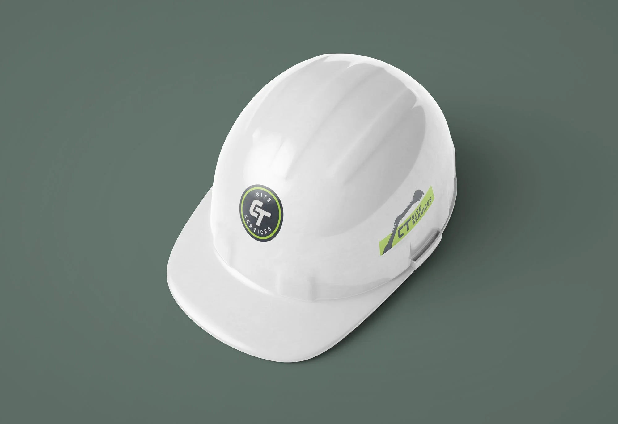 White hard hat with "CT Site Services" logo on a green background.