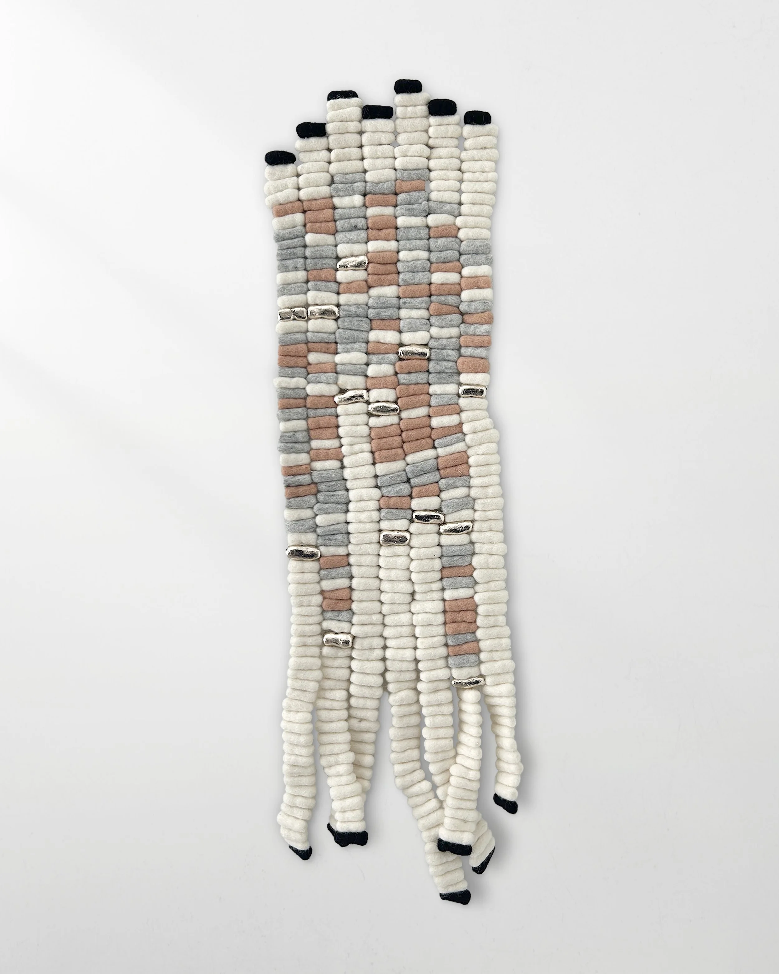 Christina Jensen Vicente, Rate of Exchange, 2024, Felted wool, clay, metal leaf, Morse code, 33 x 9 inches, $1,200