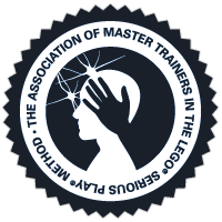 Seal or badge of the Association of Master Trainers in the Ecolise, featuring a hand and a person's profile inside a circular border.